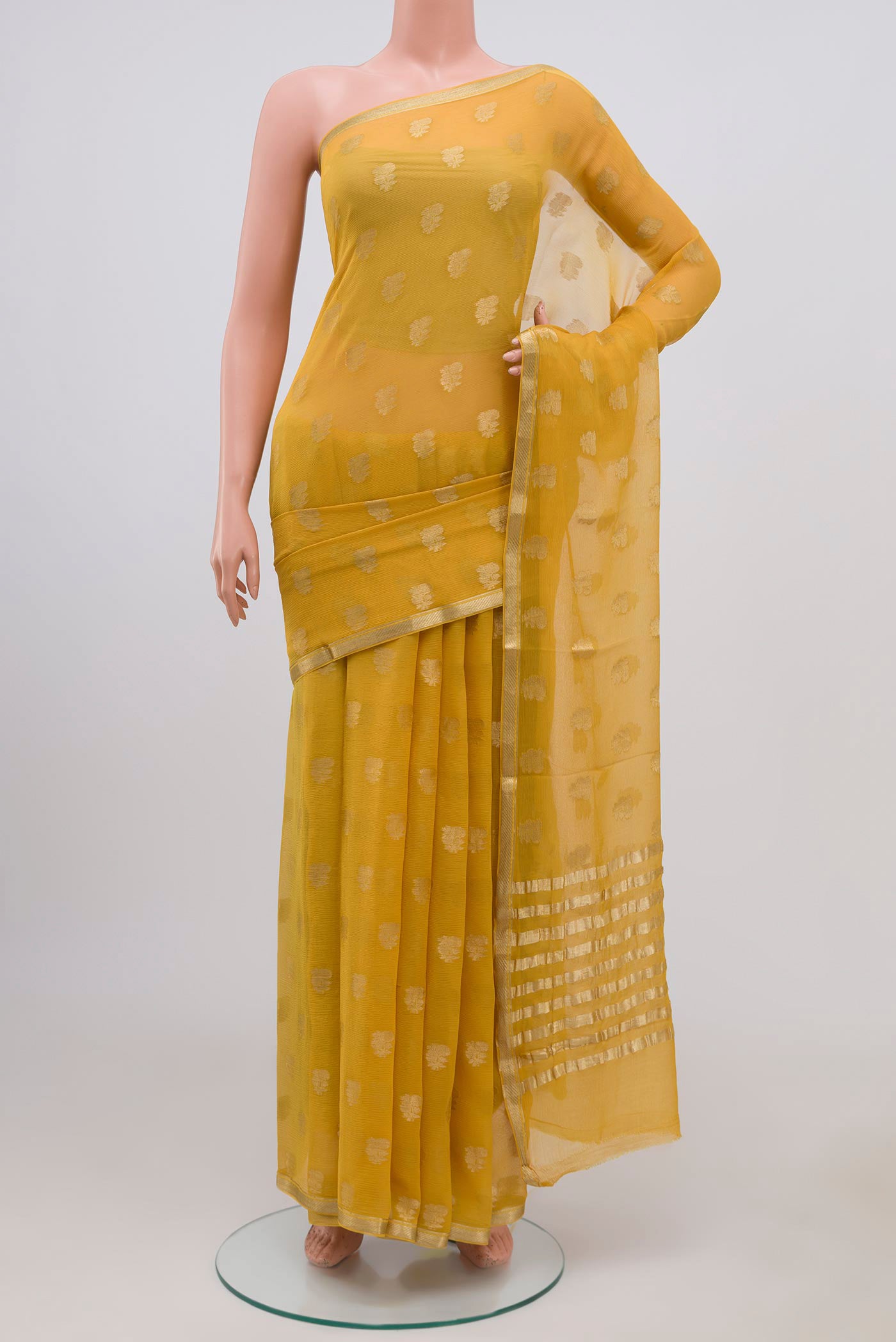 Yellow Chiffon Saree with Zari Butta on the body and Zari Border.  displayed on a mannequin