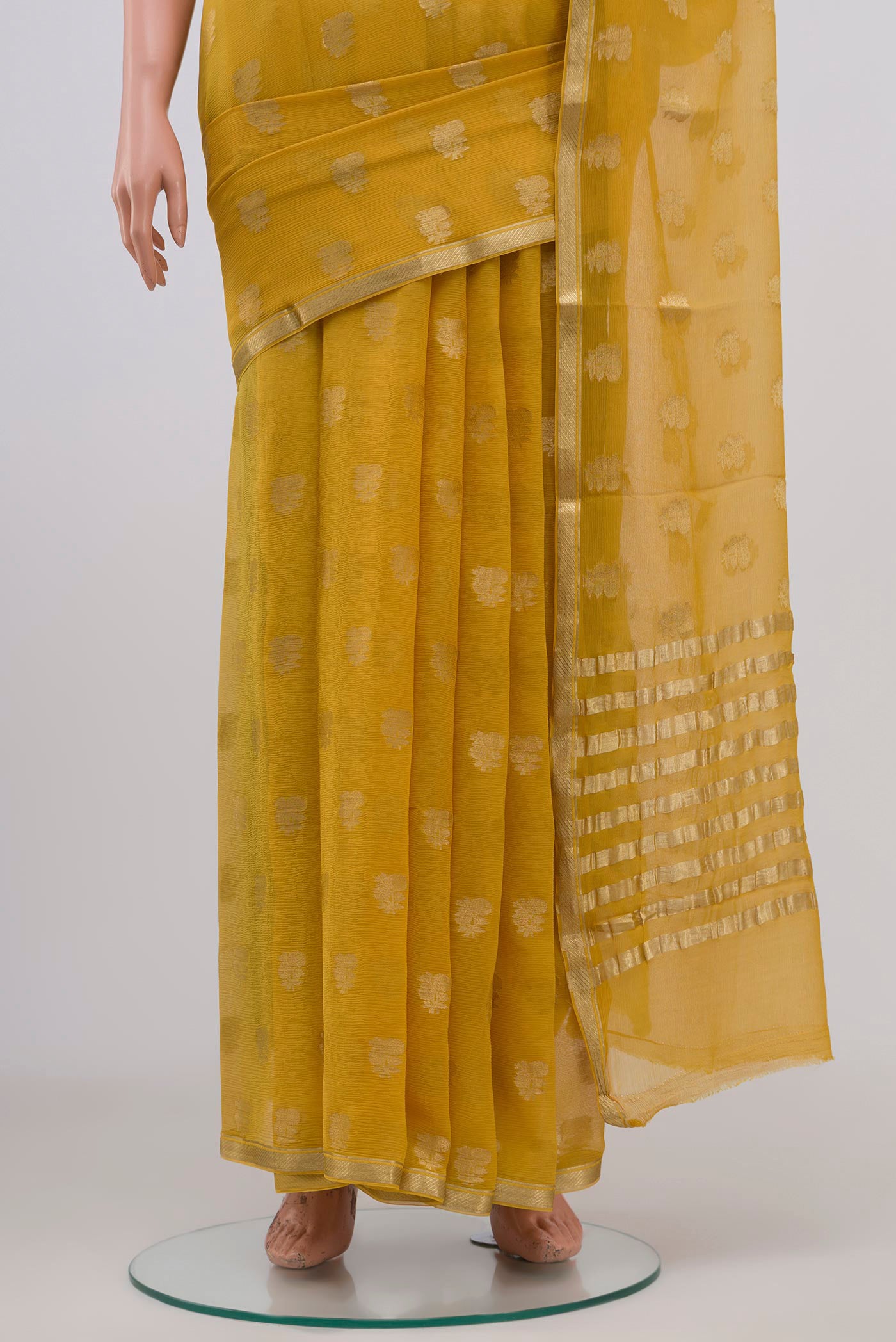 Pleats and pallu of Yellow Chiffon Saree with Zari Butta on the body and Zari Border. 