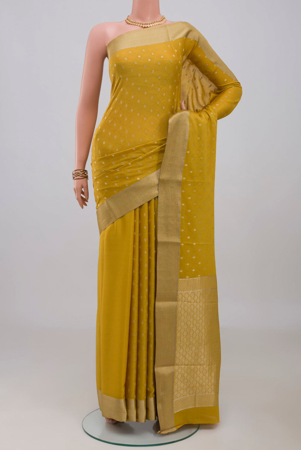 Yellow Mysore Crepe Saree with Jacquard With Zari Butta on the body and Zari Border.  displayed on a mannequin