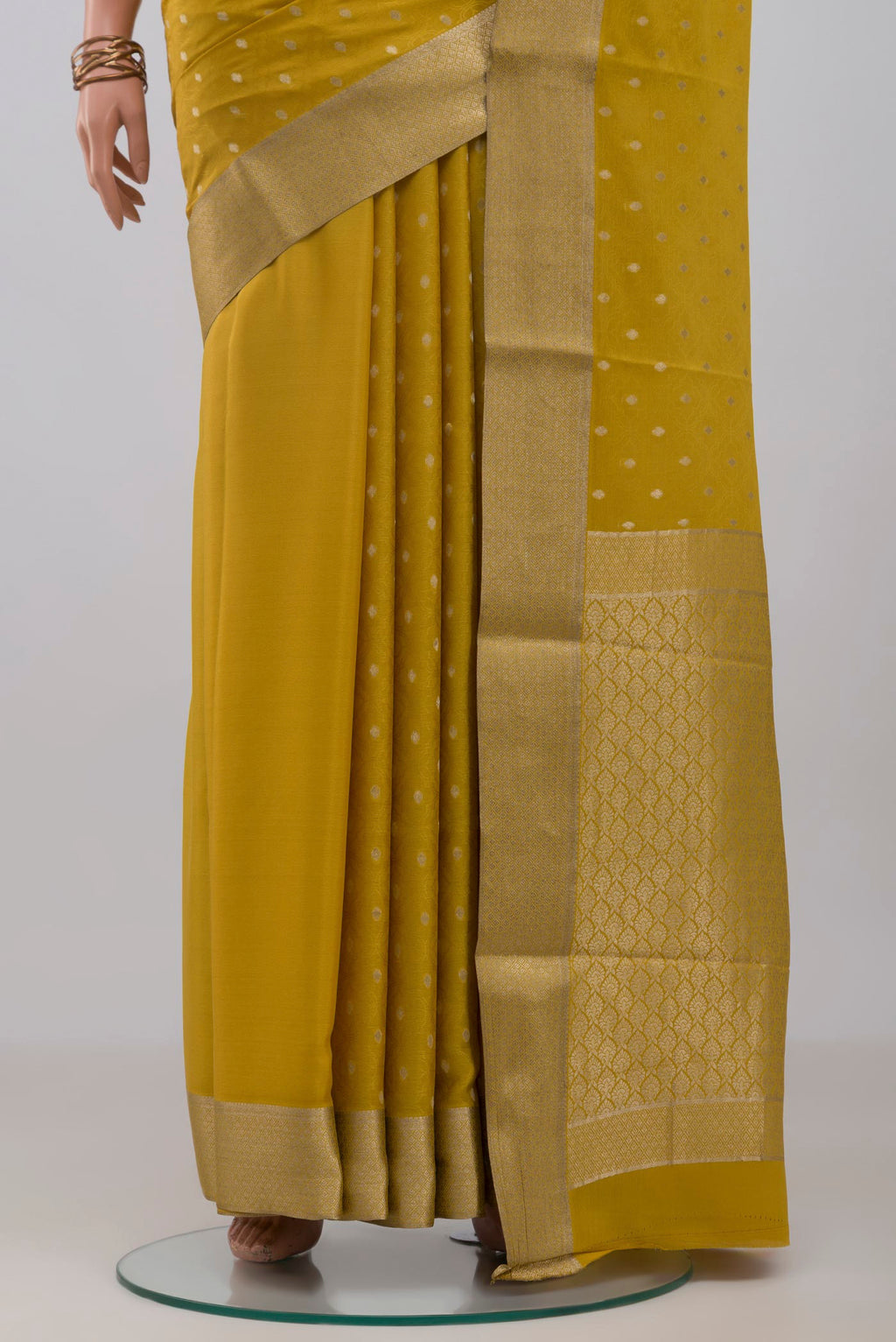 Pleats and pallu of Yellow Mysore Crepe Saree with Jacquard With Zari Butta on the body and Zari Border. 