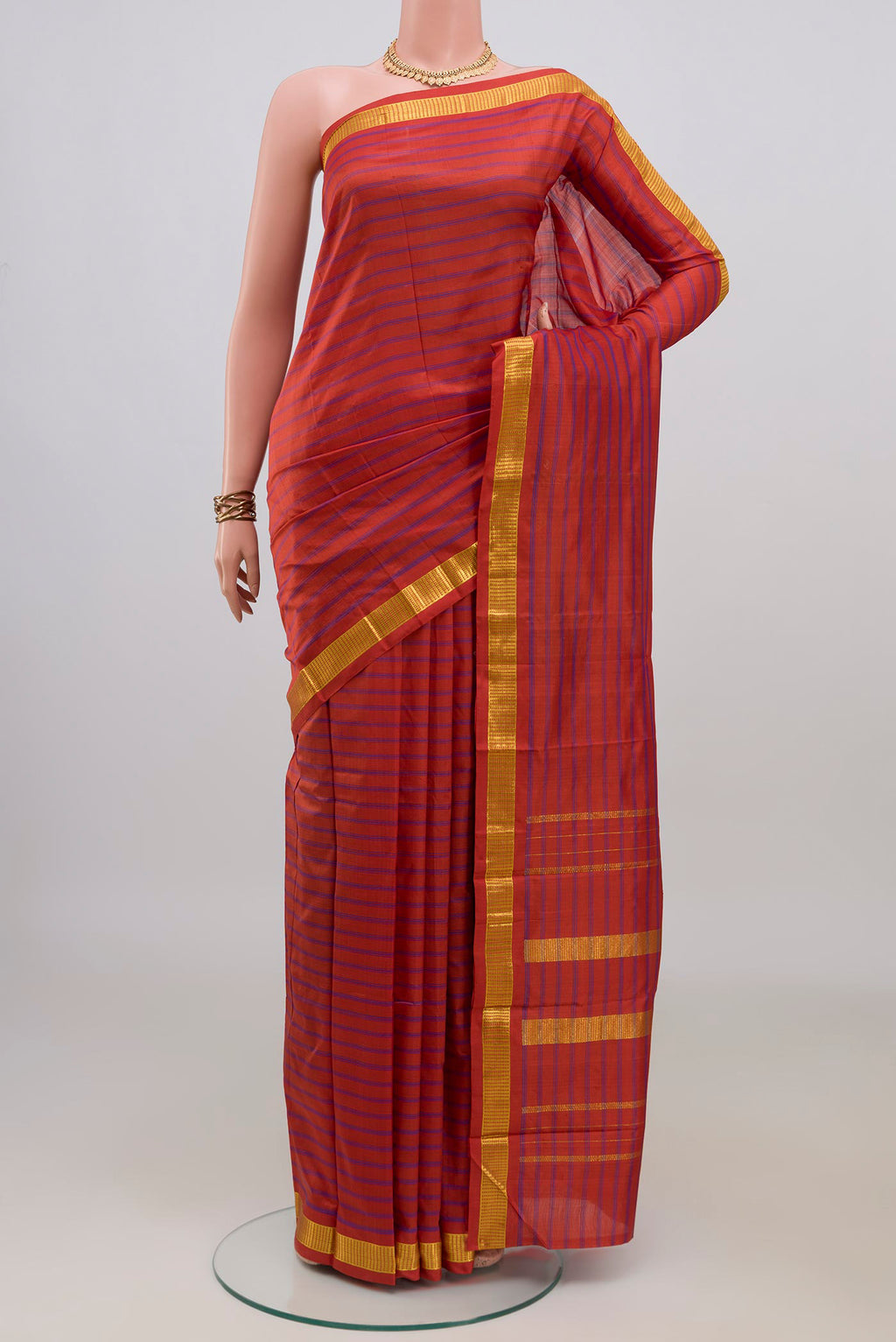 Pure Silk Orange Kanchipuram Saree with Stripes on the body and Zari Border.  displayed on a mannequin