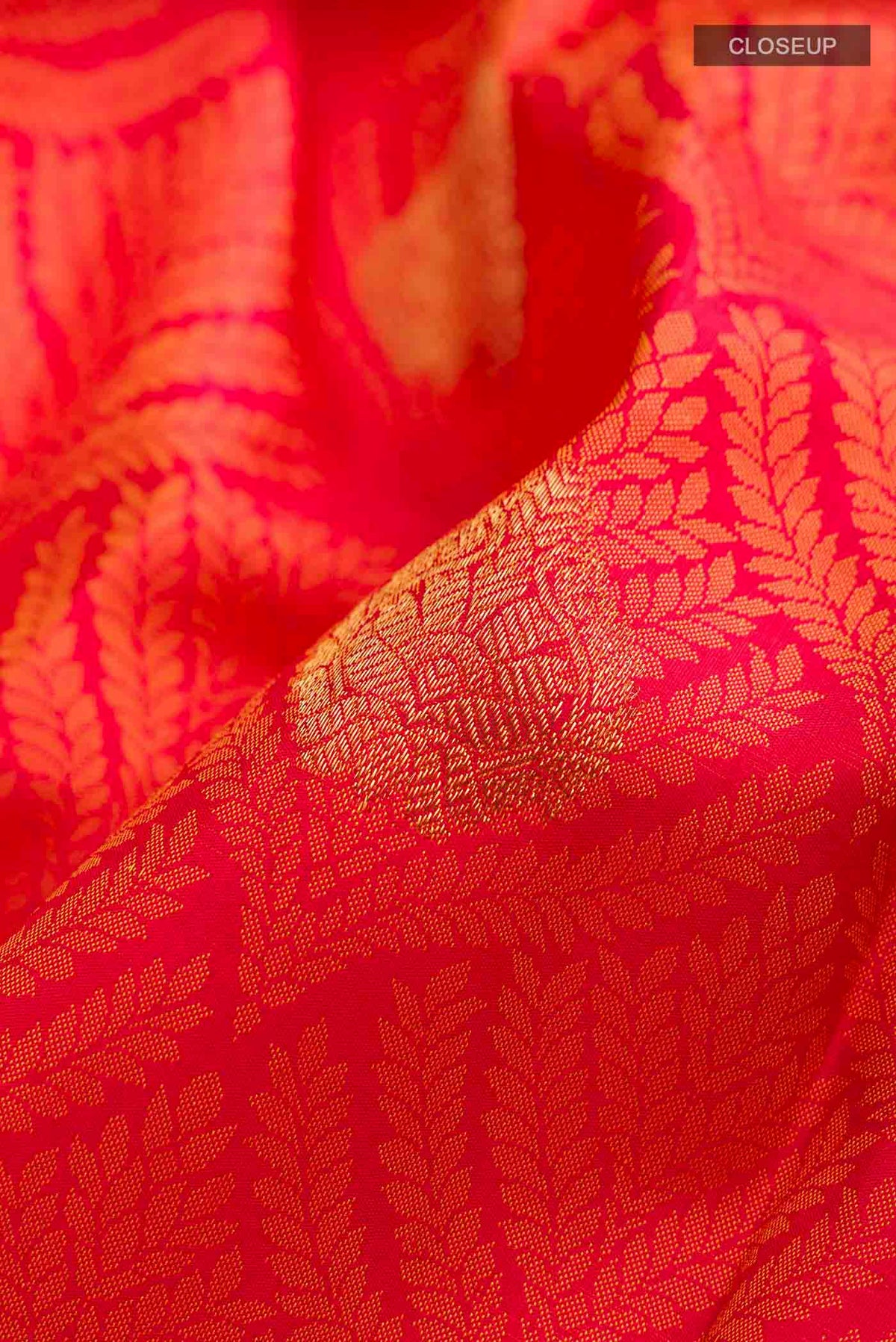 Close up of Red Kanchipuram Silk Saree with Jacquard With Zari Butta on the body and Zari Border displaying folds