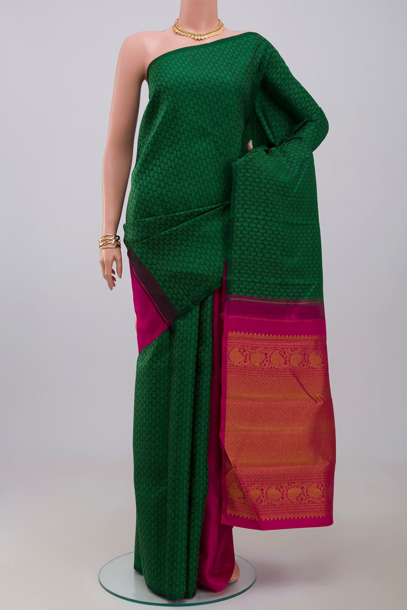 Green Kanchipuram Saree with Partli on the body and Without Border.  displayed on a mannequin