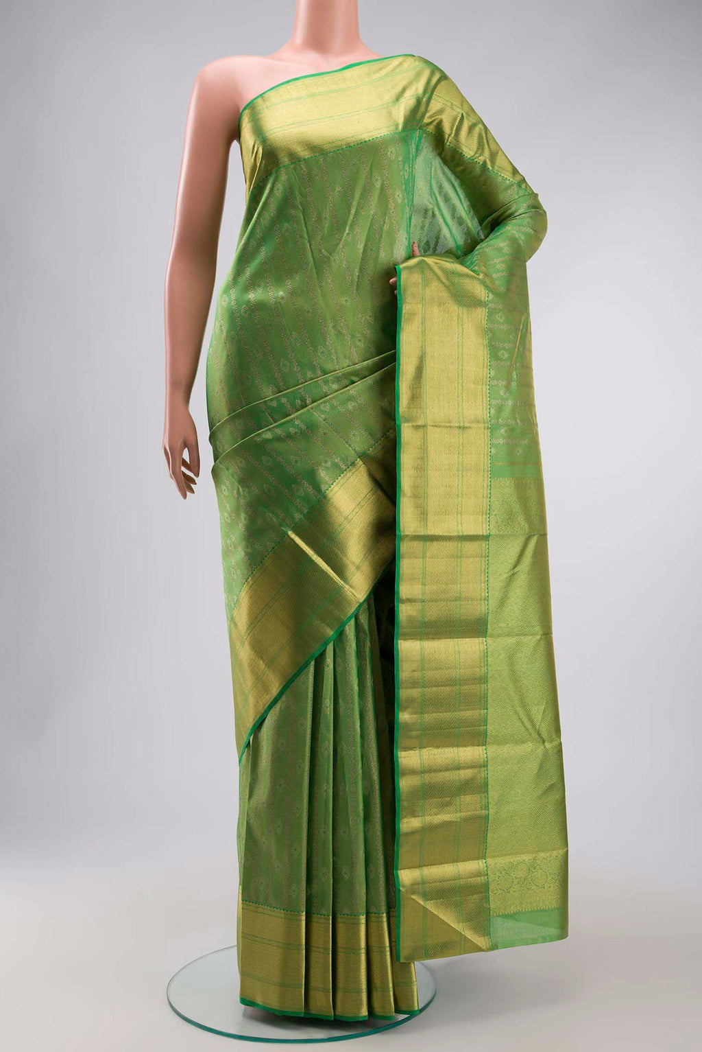 Green Kanchipuram Silk Saree with Zari Butta on the body and Zari Border displayed on a mannequin