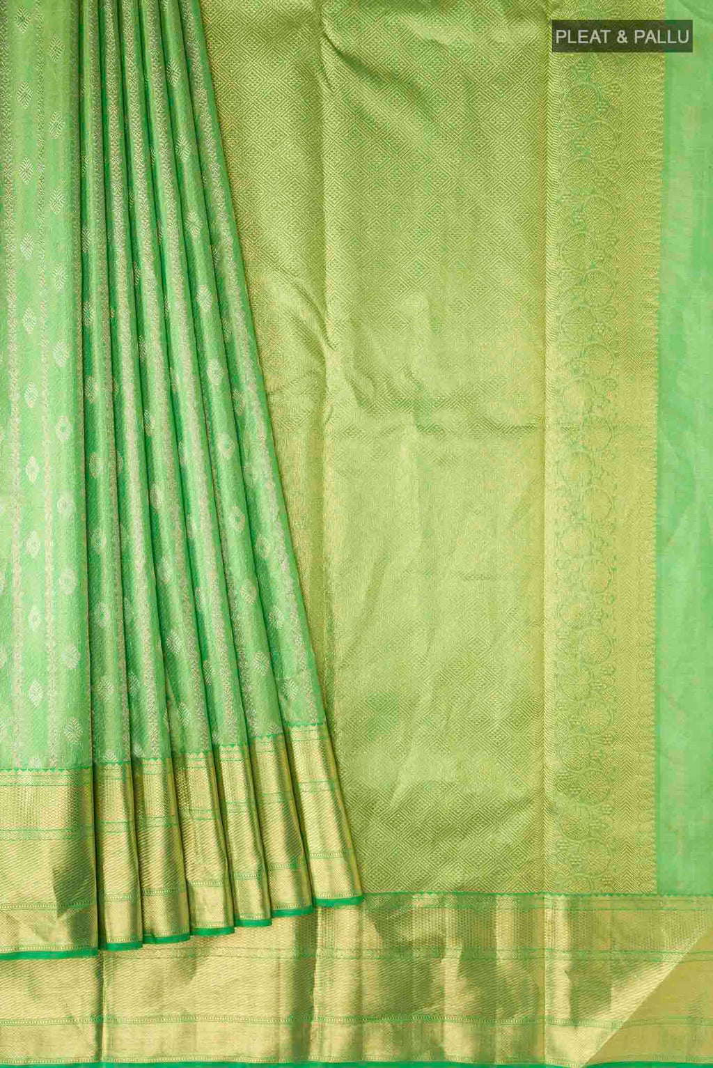 Pleats and pallu of Green Kanchipuram Silk Saree with Zari Butta on the body and Zari Border