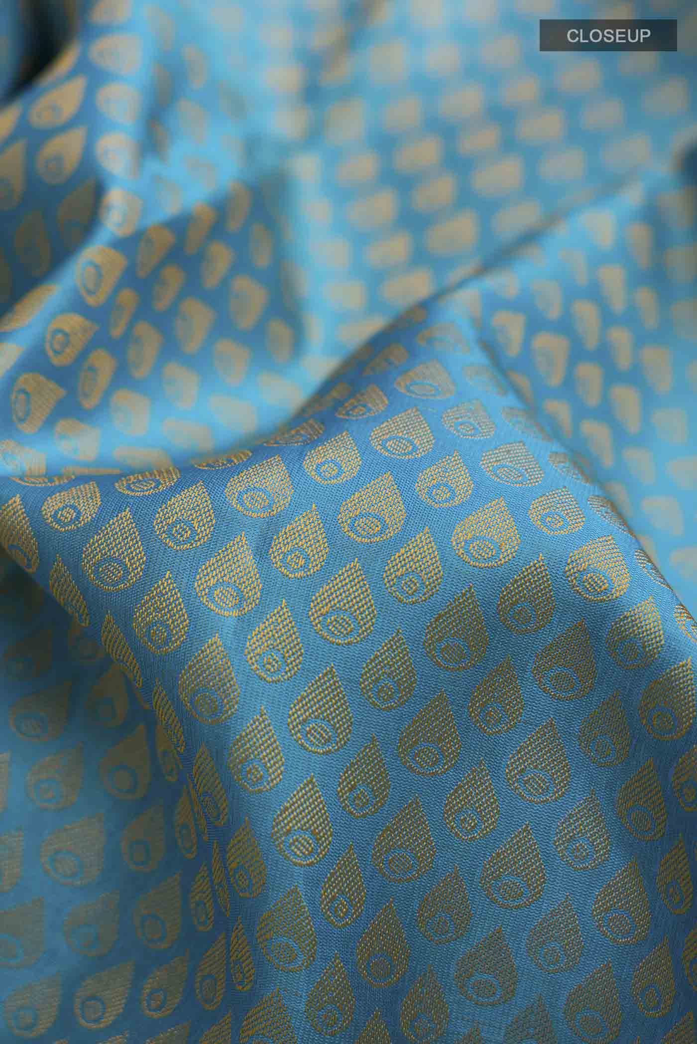 Close up of Blue Kanchipuram Silk Saree with Jacquard design on the body and Zari Border displaying folds