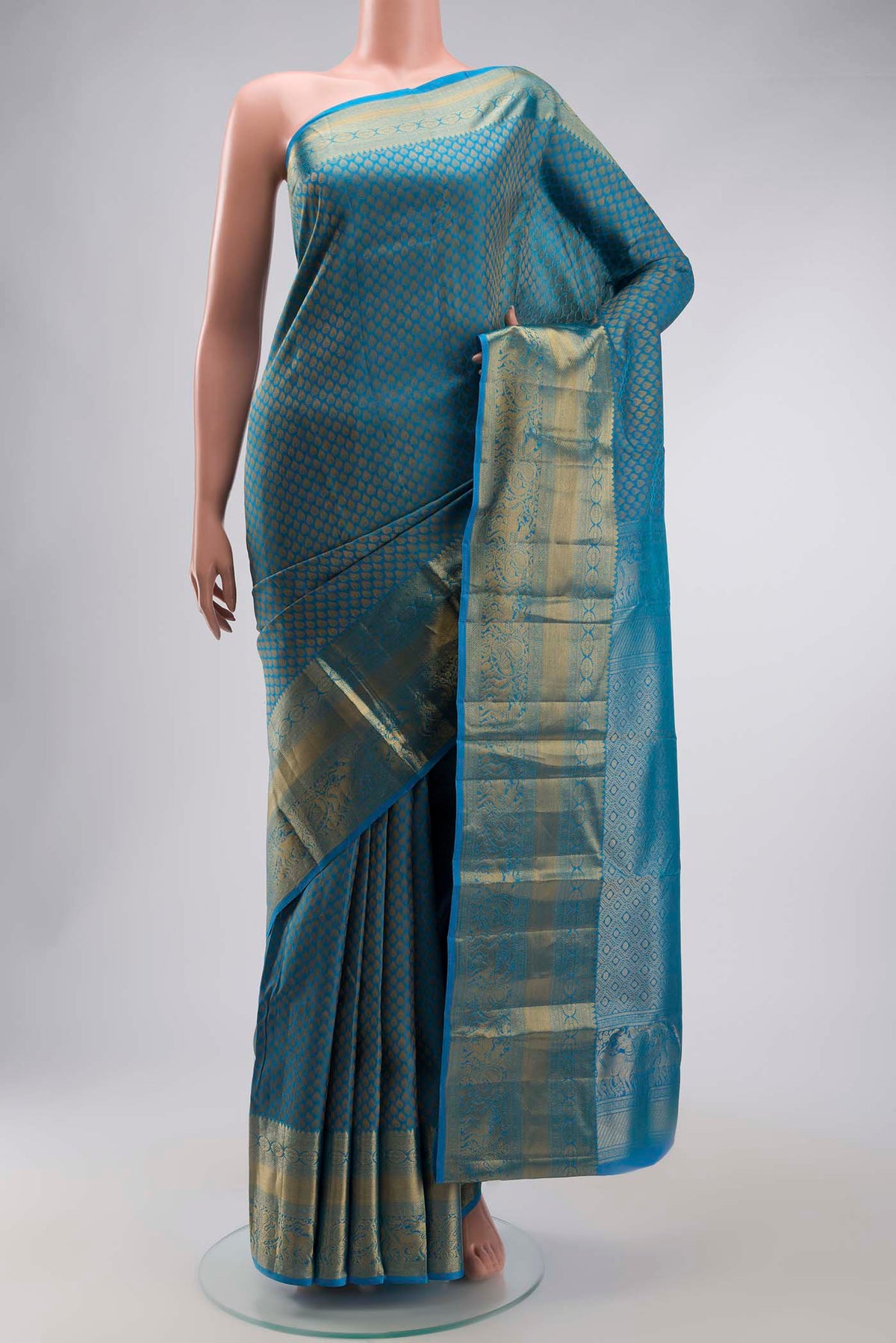 Blue Kanchipuram Silk Saree with Jacquard design on the body and Zari Border displayed on a mannequin