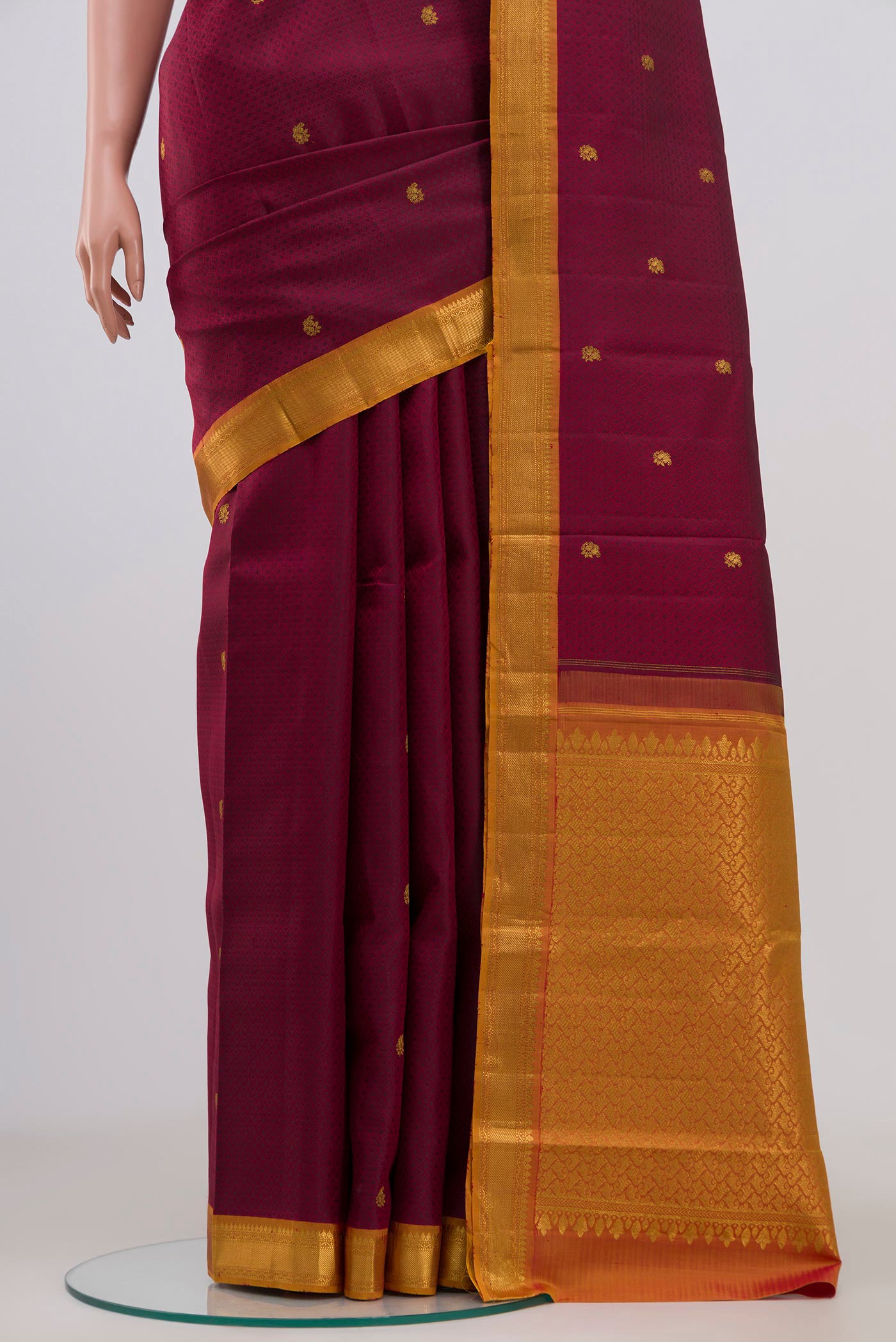 Pleats and pallu of Maroon Kanchipuram Saree with Jacquard With Zari Butta on the body and Zari Border. 