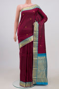 Maroon Kanjivaram Saree with Jacquard With Zari Butta on the body and Zari Border.  displayed on a mannequin