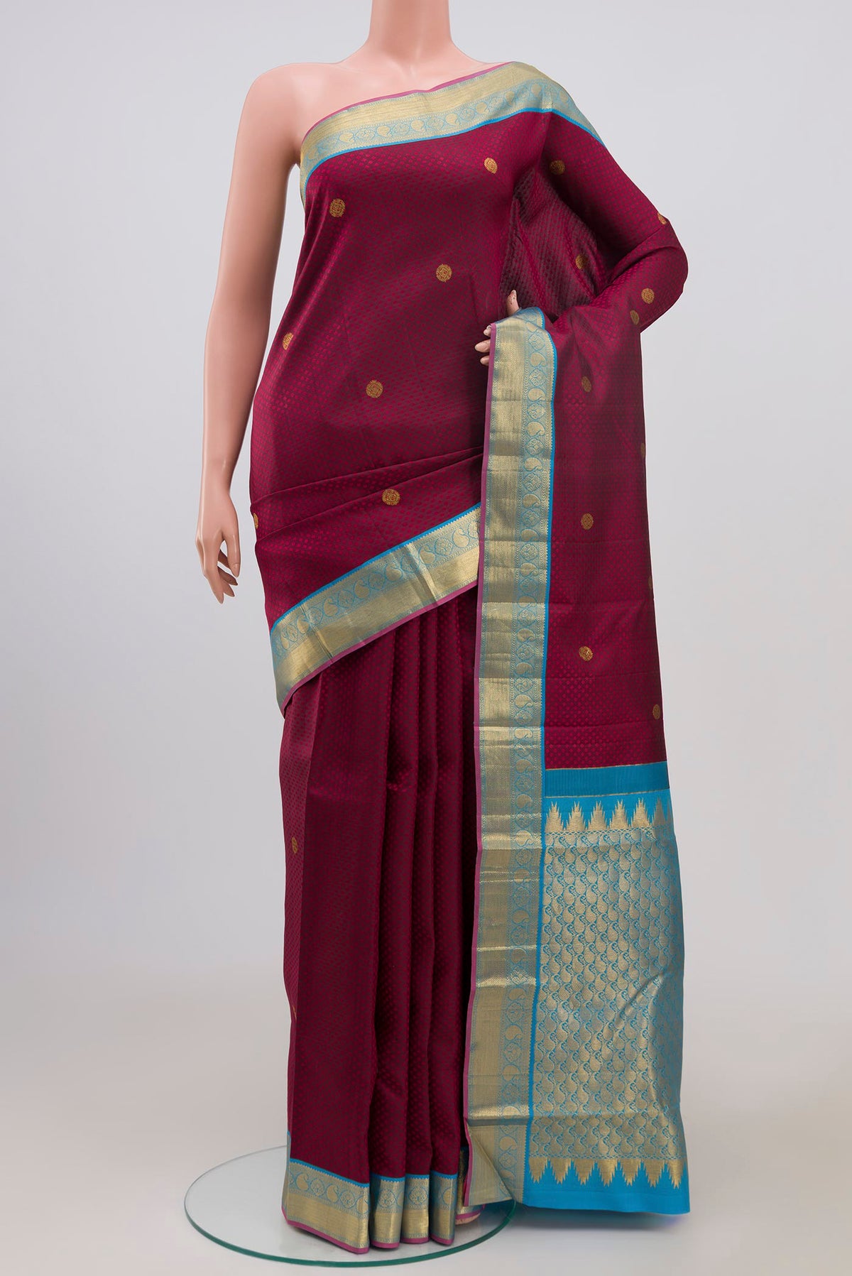 Maroon Kanjivaram Saree with Jacquard With Zari Butta on the body and Zari Border.  displayed on a mannequin