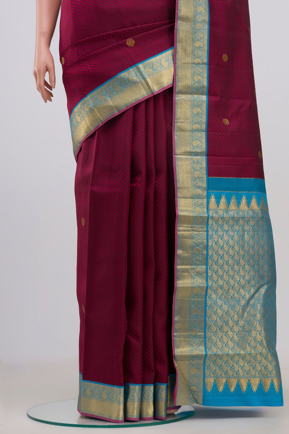 Pleats and pallu of Maroon Kanjivaram Saree with Jacquard With Zari Butta on the body and Zari Border. 