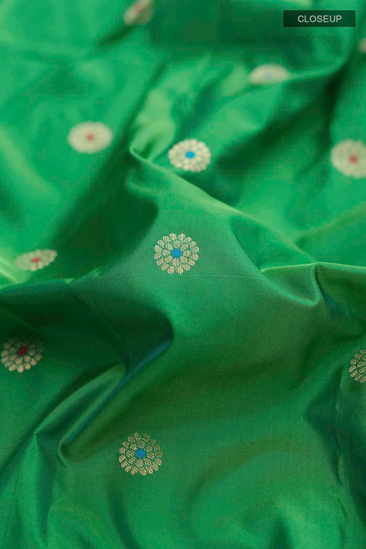 Close up of Green Blended Bangalore Silk Saree with Zari Butta on the body and Zari Border displaying folds