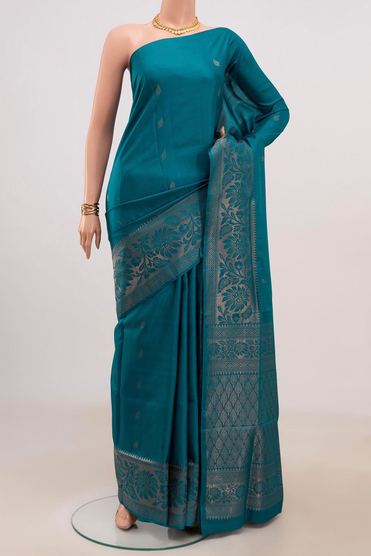 Blue Soft Silk Saree with Zari Butta on the body and Fancy Border.  displayed on a mannequin