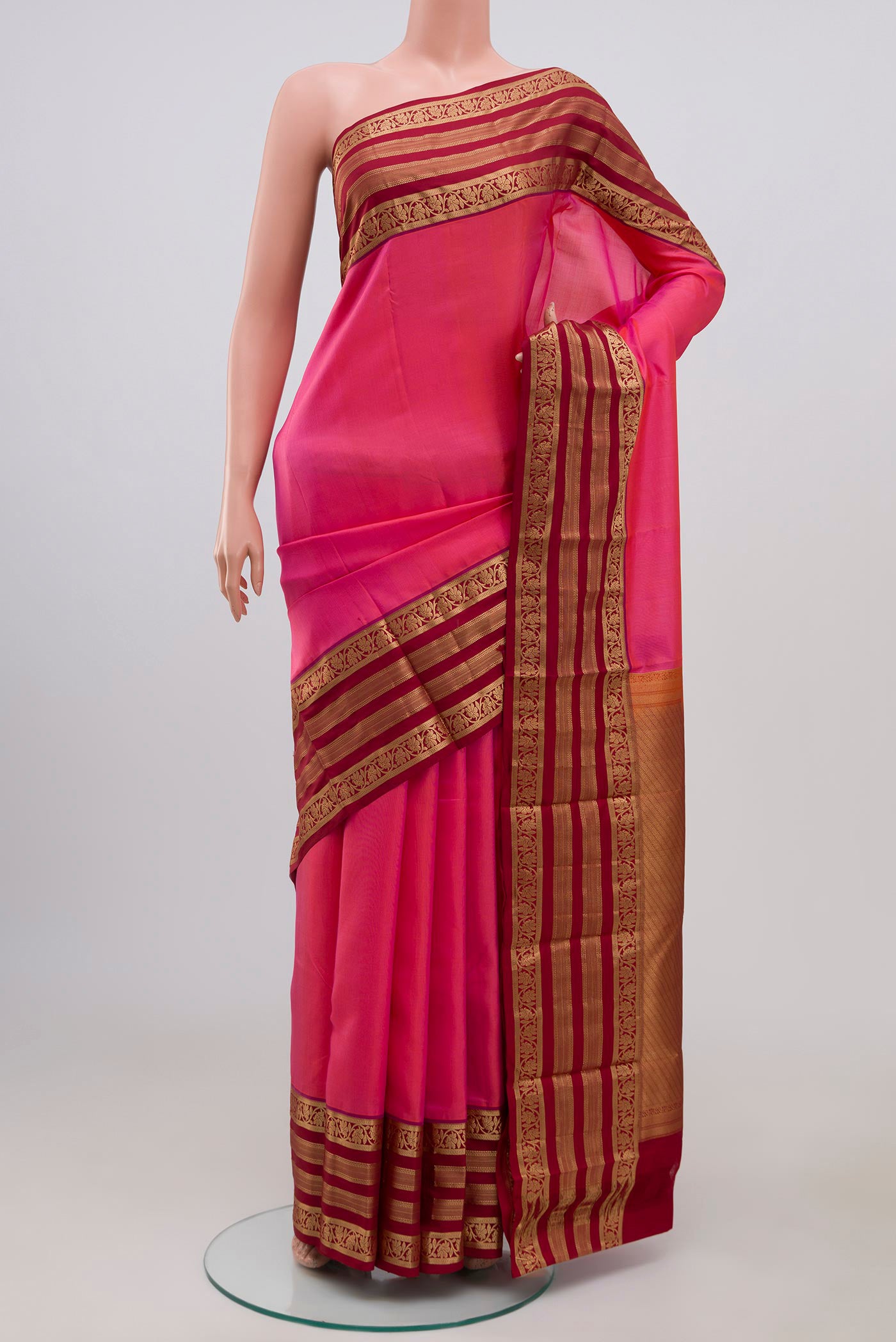 Pink Kanchipuram Silk Saree with Plain Body and Zari Border.  displayed on a mannequin