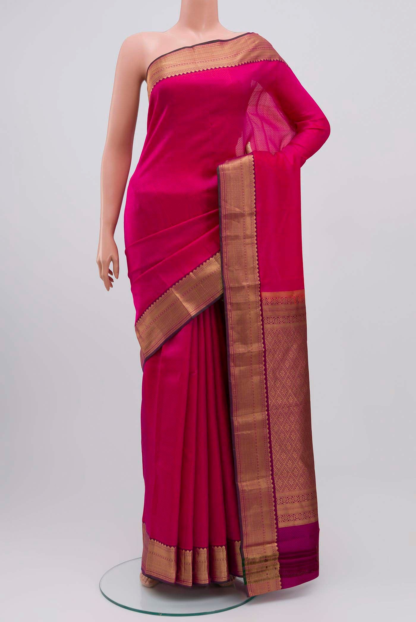 Rani Pink Kanchipuram Silk Saree with Jacquard design on the body and Zari Border displayed on a mannequin