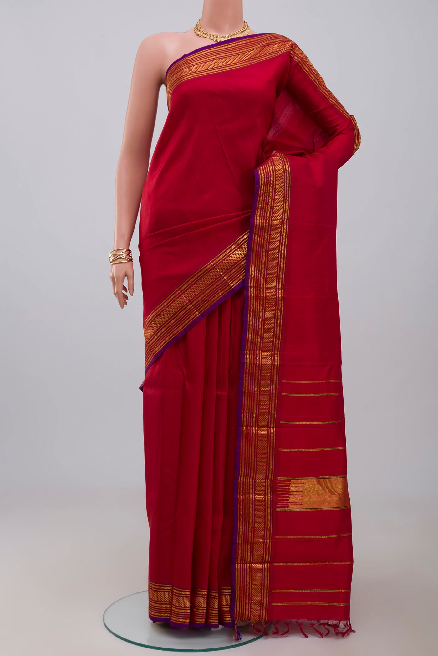 Pure Silk Pure Zari Red Kanjivaram Saree with Plain Body and Zari Border.  displayed on a mannequin