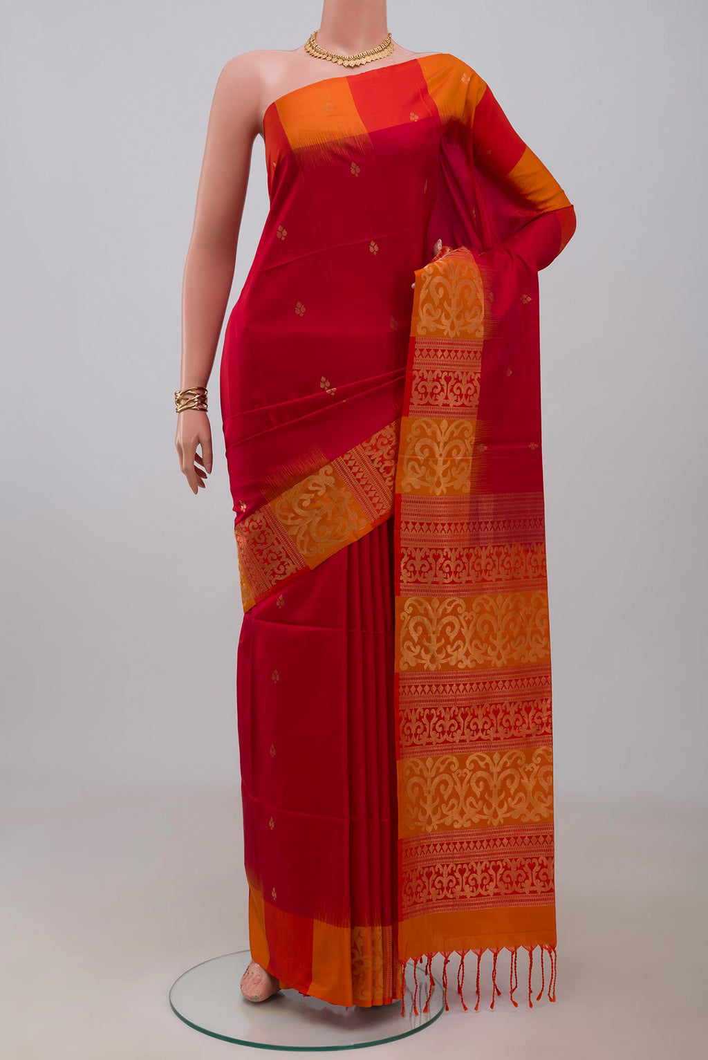 Red Soft Silk Saree with Zari Butta on the body and Fancy Border.  displayed on a mannequin