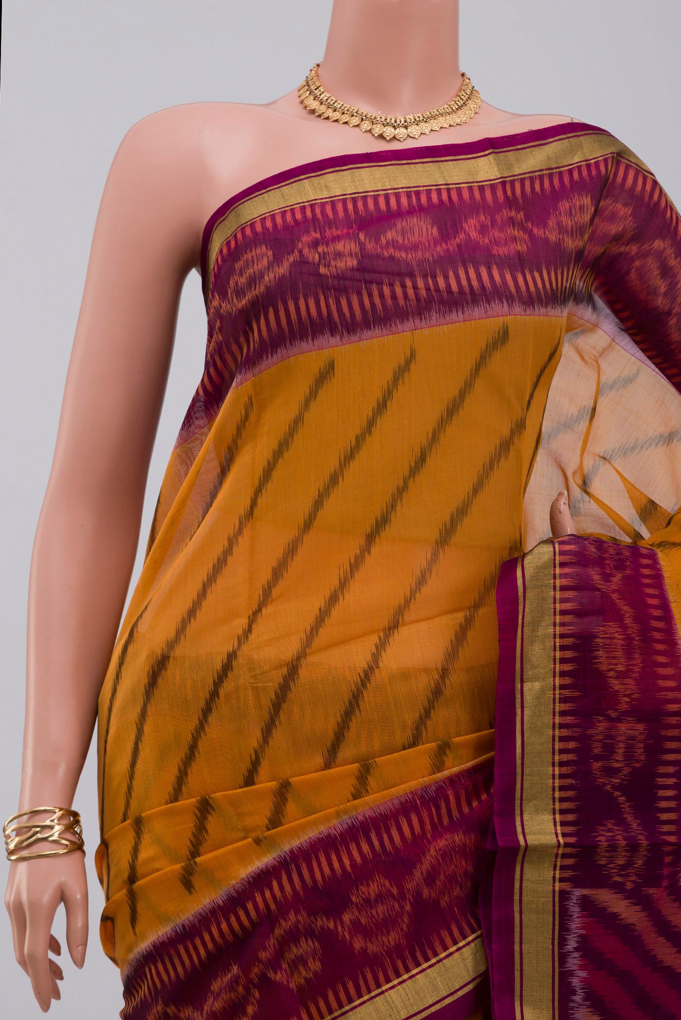 Border image of Yellow Silk Cotton Saree with Ikat Print on the body and Thin Zari Line. 