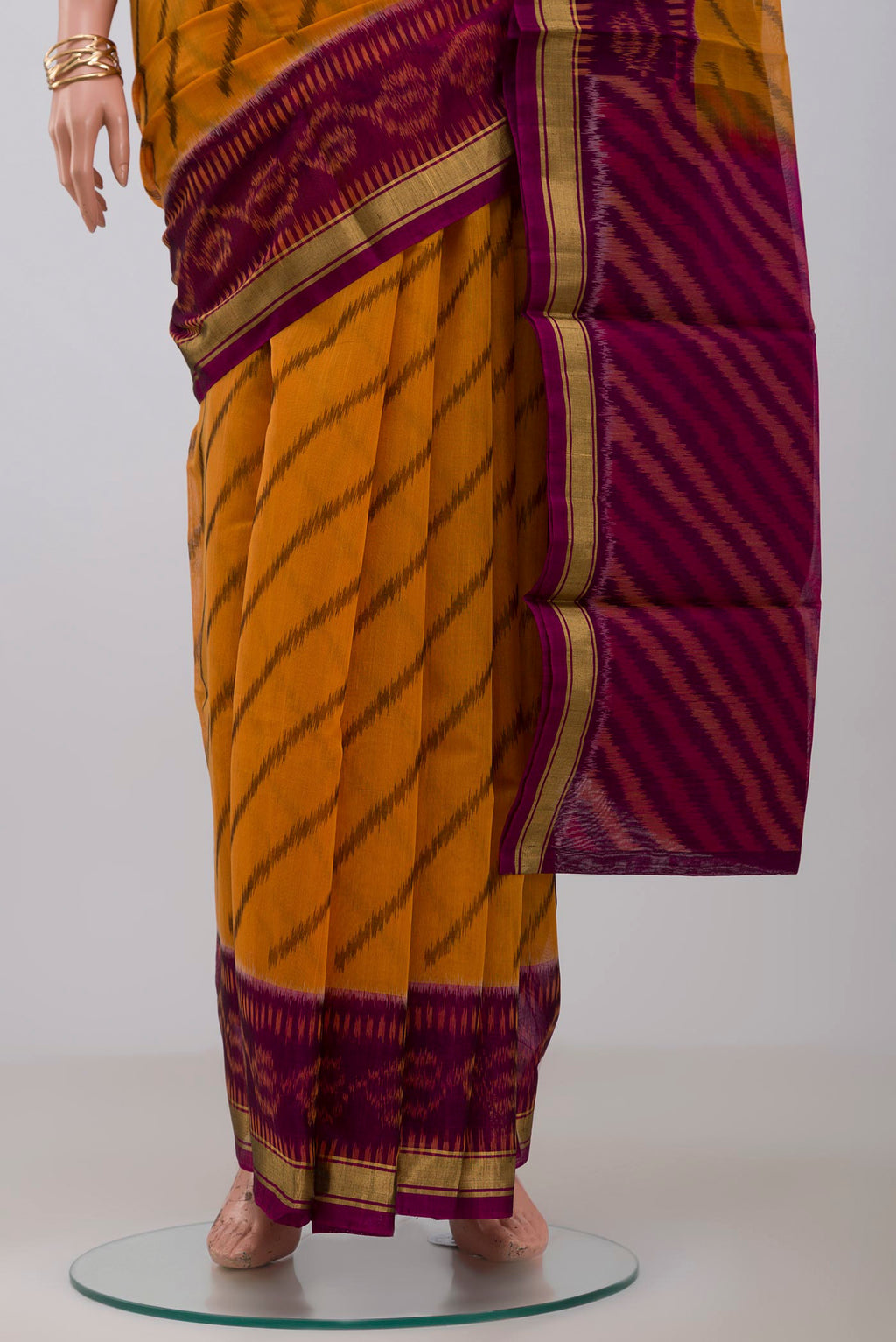 Pleats and pallu of Yellow Silk Cotton Saree with Ikat Print on the body and Thin Zari Line. 