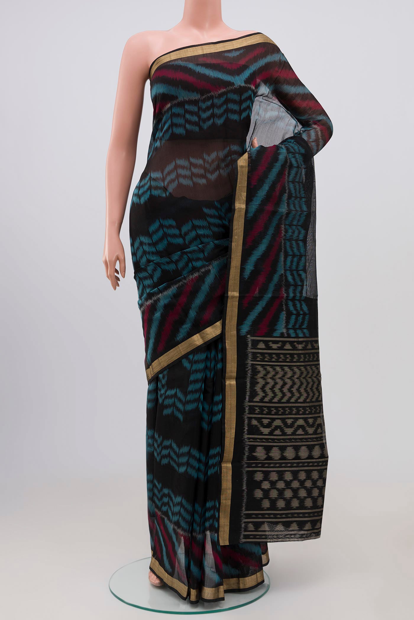 Black Coimbatore Silk Cotton Saree with Ikat Print on the body and Zari Border.  displayed on a mannequin