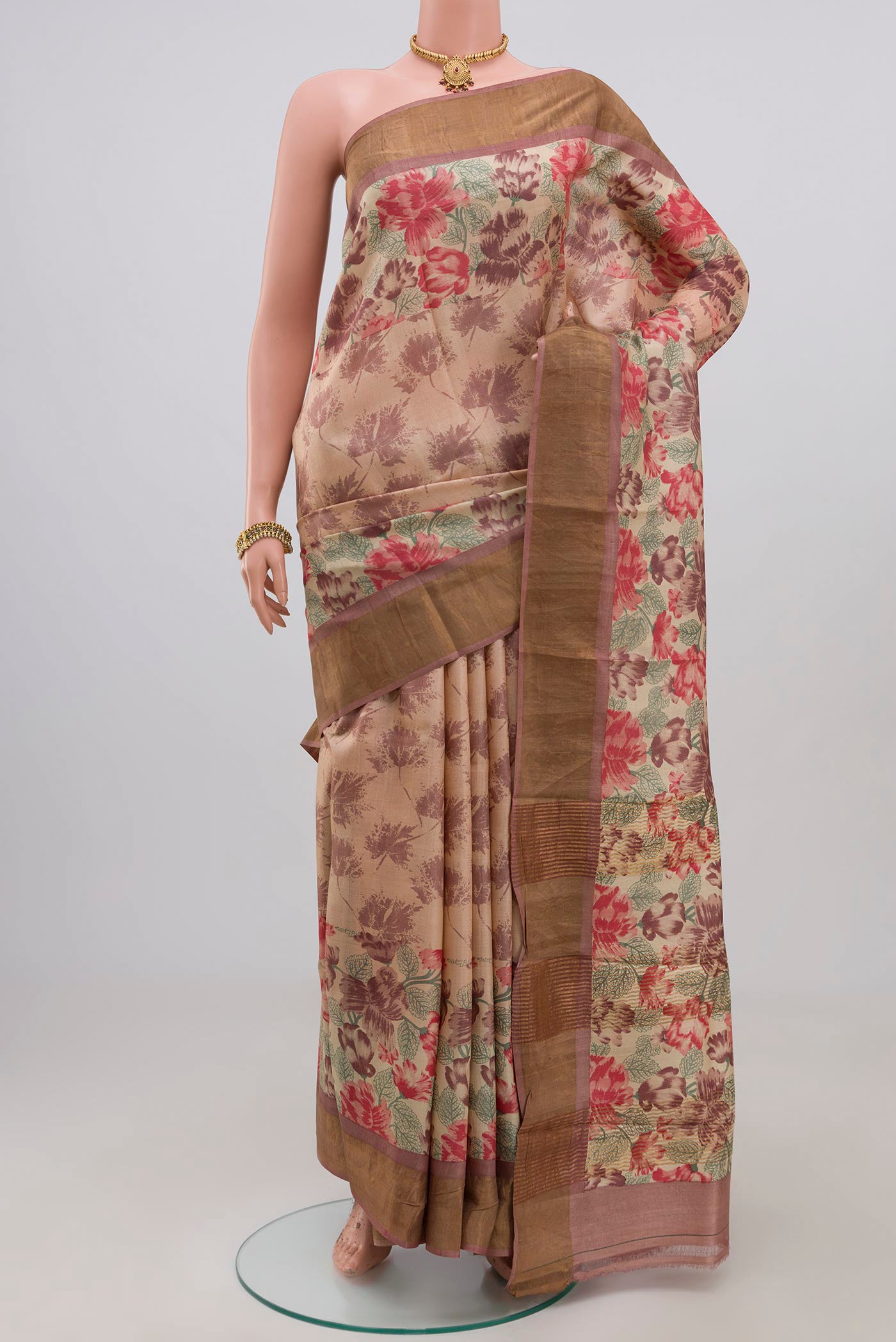 Cream Tussar Silk Saree with Printed design on the body and Zari Border.  displayed on a mannequin
