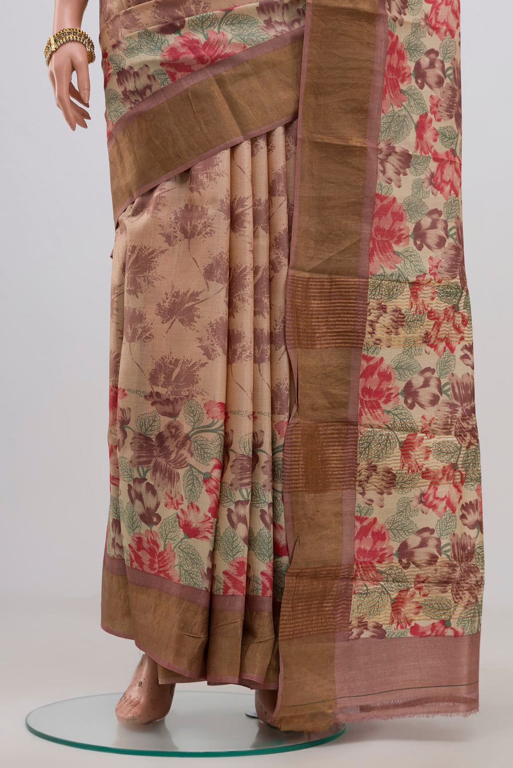 Pleats and pallu of Cream Tussar Silk Saree with Printed design on the body and Zari Border. 