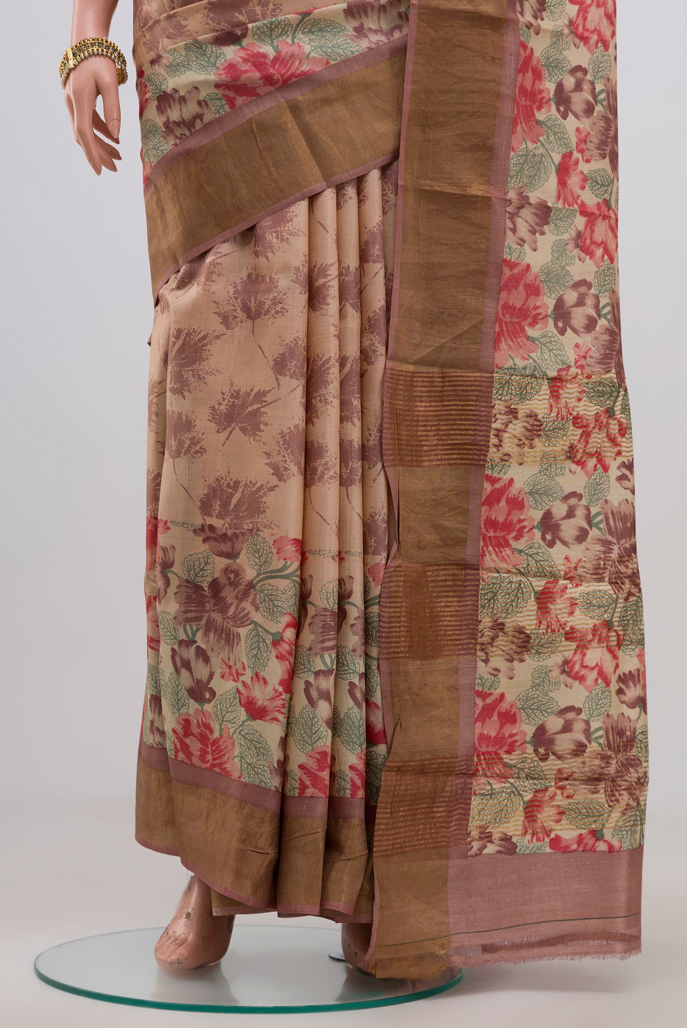Pleats and pallu of Cream Tussar Silk Saree with Printed design on the body and Zari Border. 