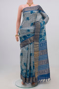 Blue Tussar Silk Saree with Printed design on the body and Zari Border.  displayed on a mannequin