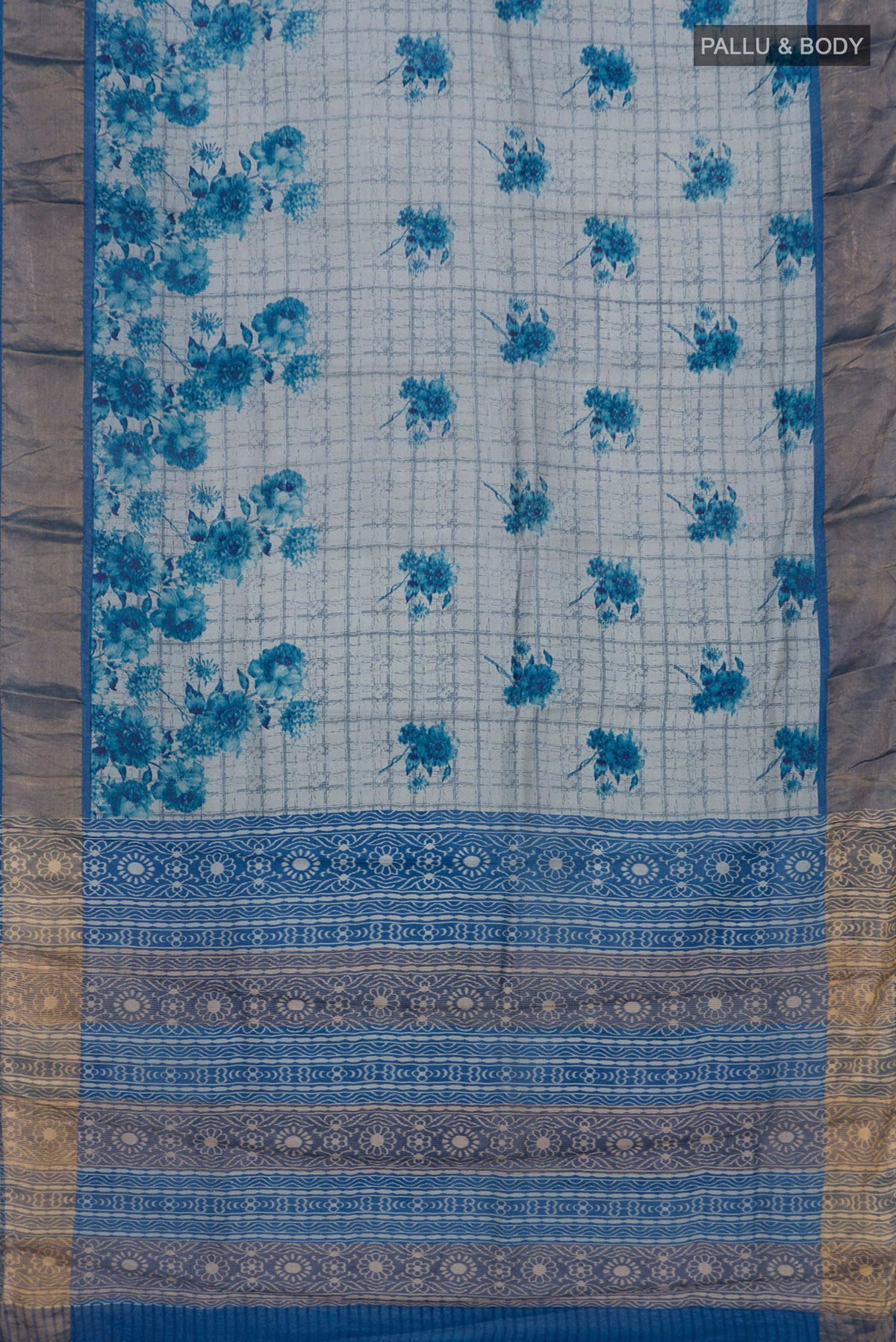 Flat view of Blue Tussar Silk Saree with Printed design on the body and Zari Border. 