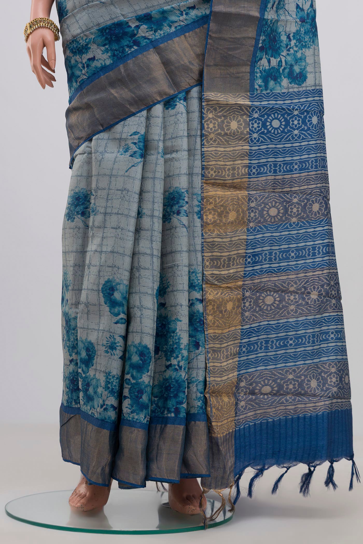 Pleats and pallu of Blue Tussar Silk Saree with Printed design on the body and Zari Border. 