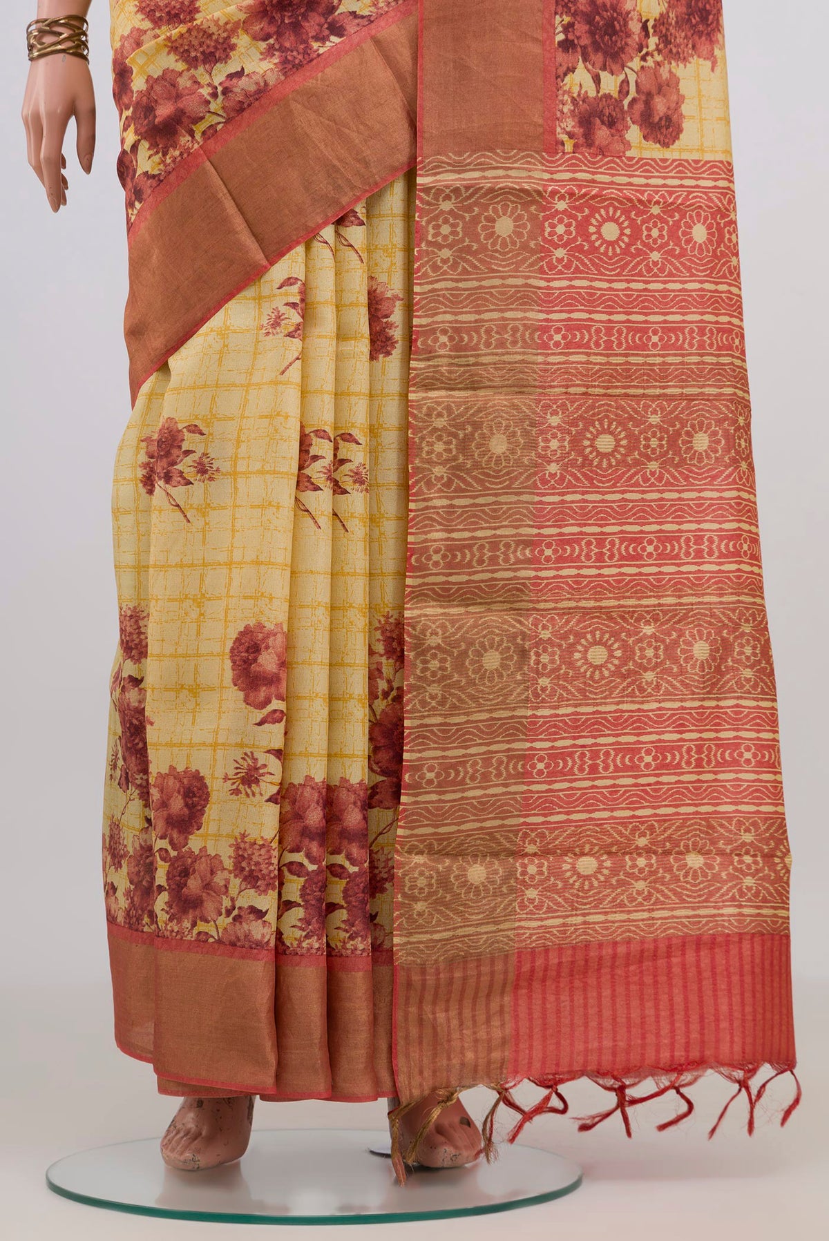 Pleats and pallu of Yellow Tussar Saree with Floral Print on the body and Zari Border. 