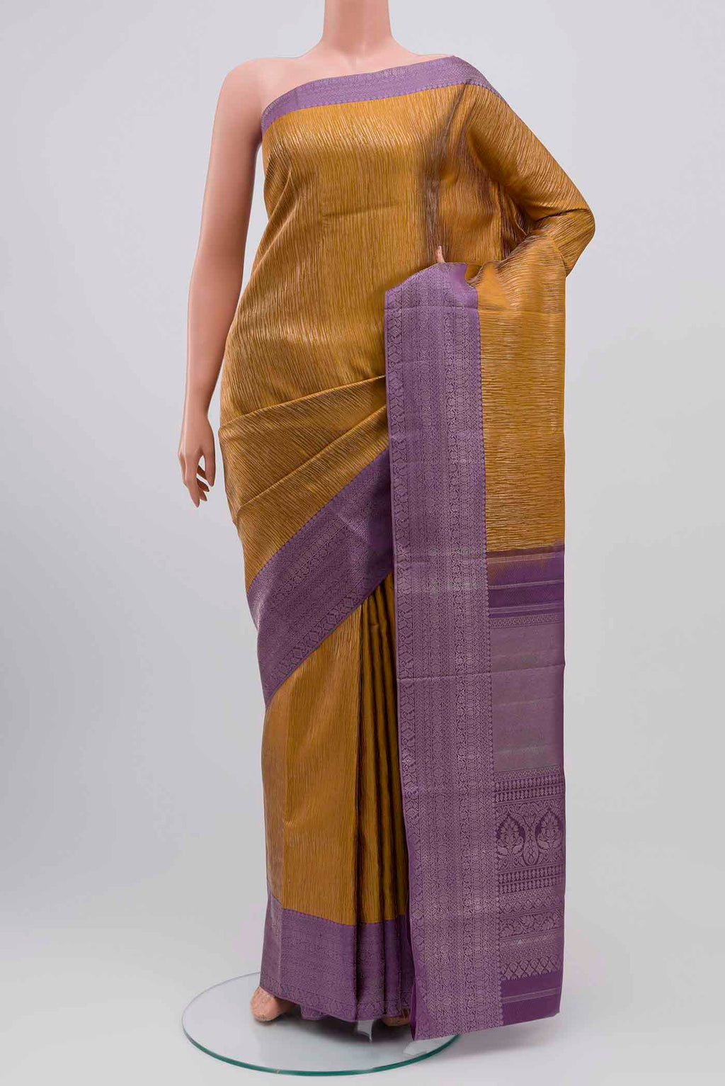 Mustard Kanchipuram Silk Saree with Zari Brocade on the body and Zari Border displayed on a mannequin