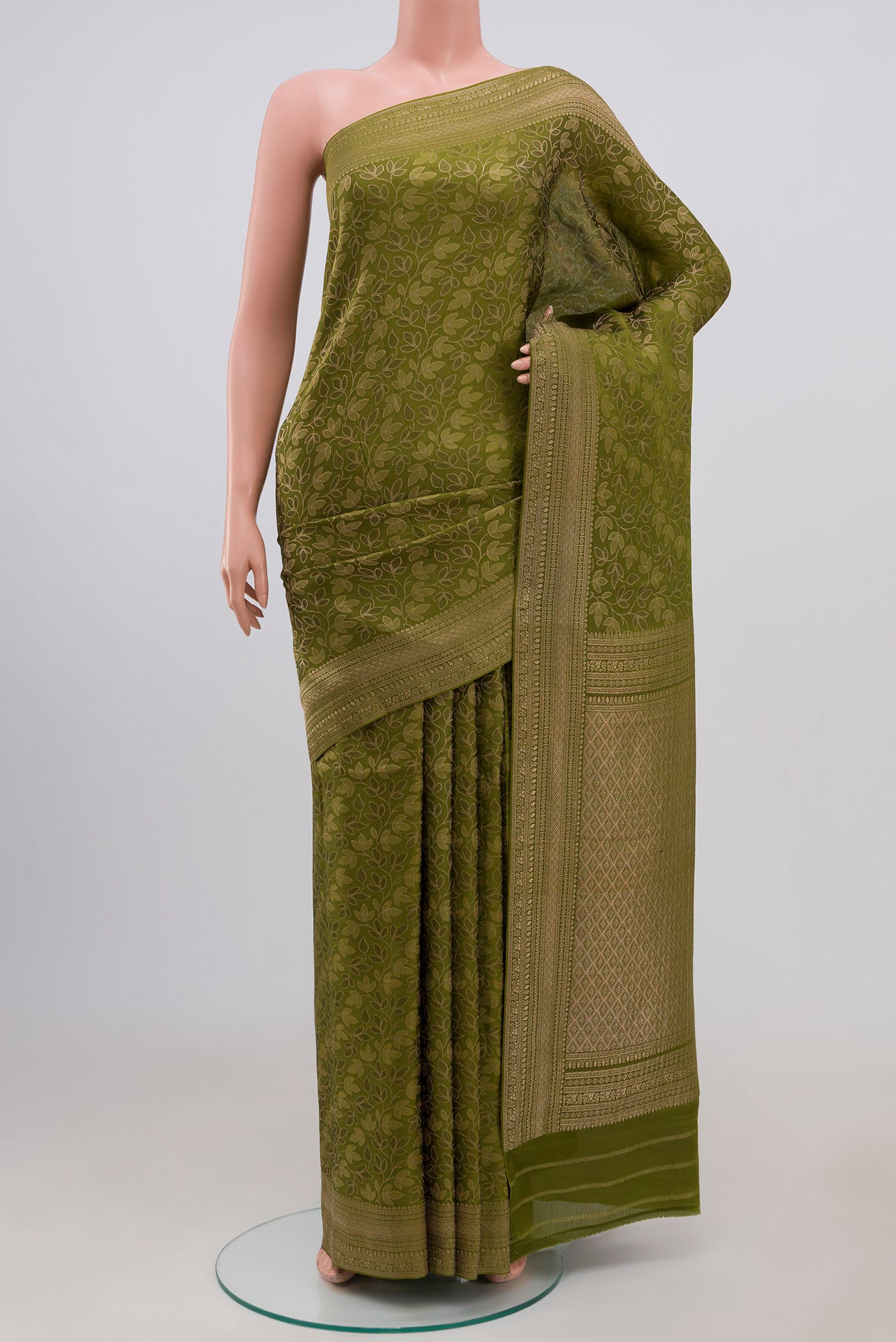Green Mysore Crepe Saree with Zari Brocade on the body and Fancy Border.  displayed on a mannequin