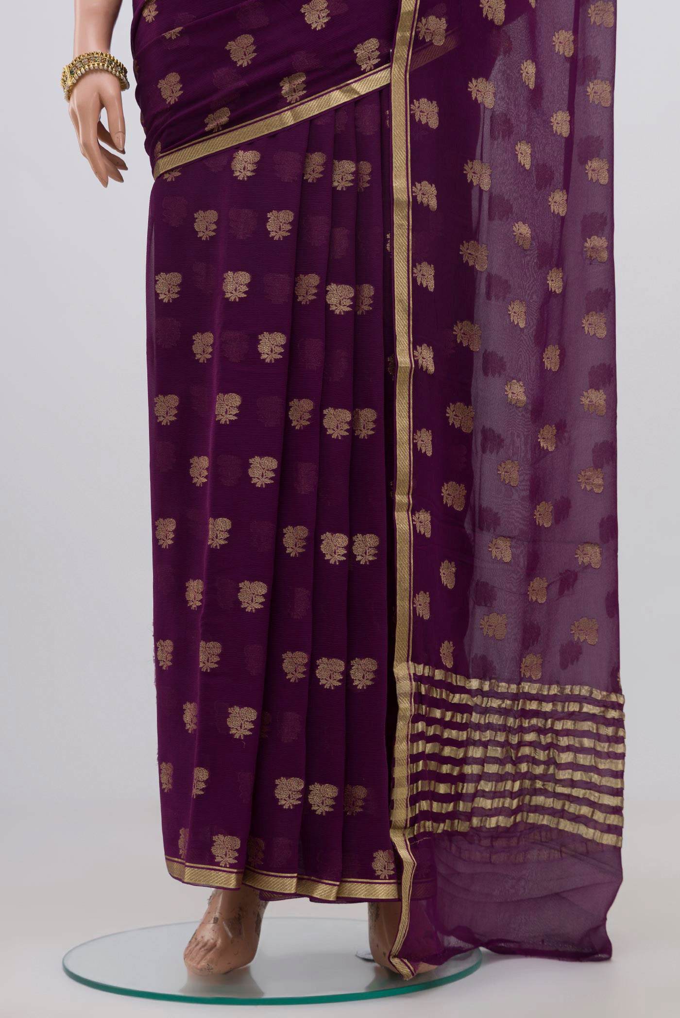 Pleats and pallu of Purple Chiffon Saree with Fancy on the body and Zari Border. 