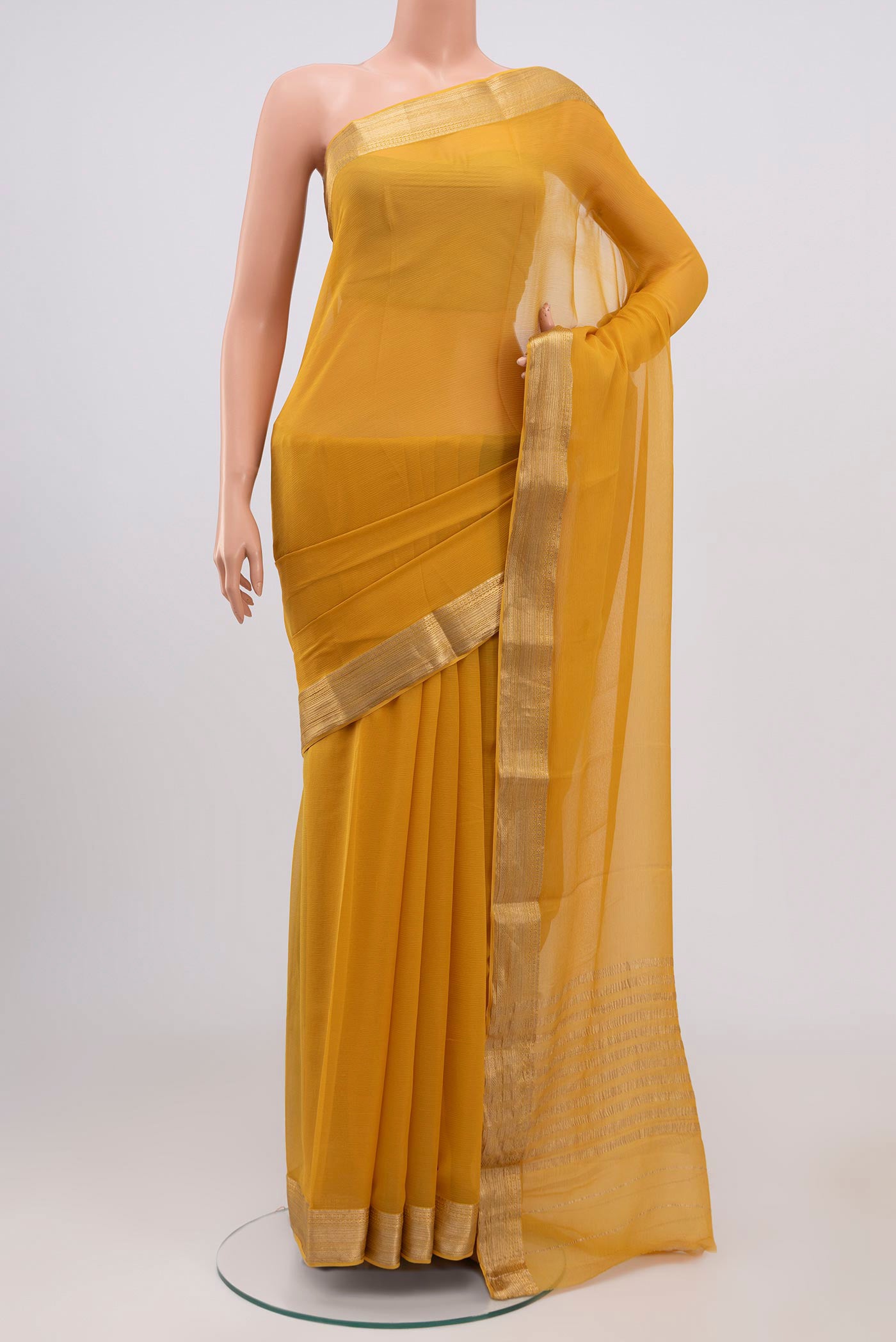 Yellow Chiffon Saree with Plain Body and Zari Border.  displayed on a mannequin