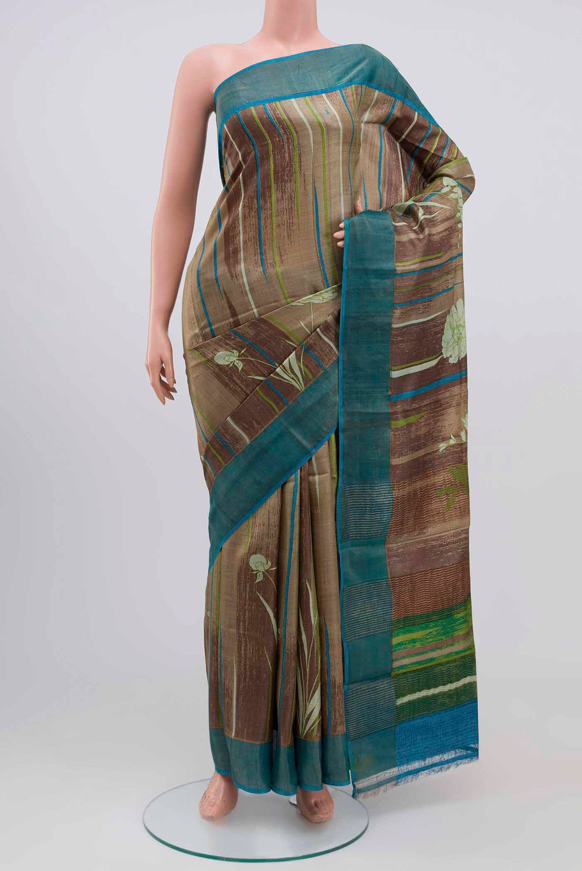 Multi Color Tussar Silk Saree with Printed design on the body and Zari Border.  displayed on a mannequin