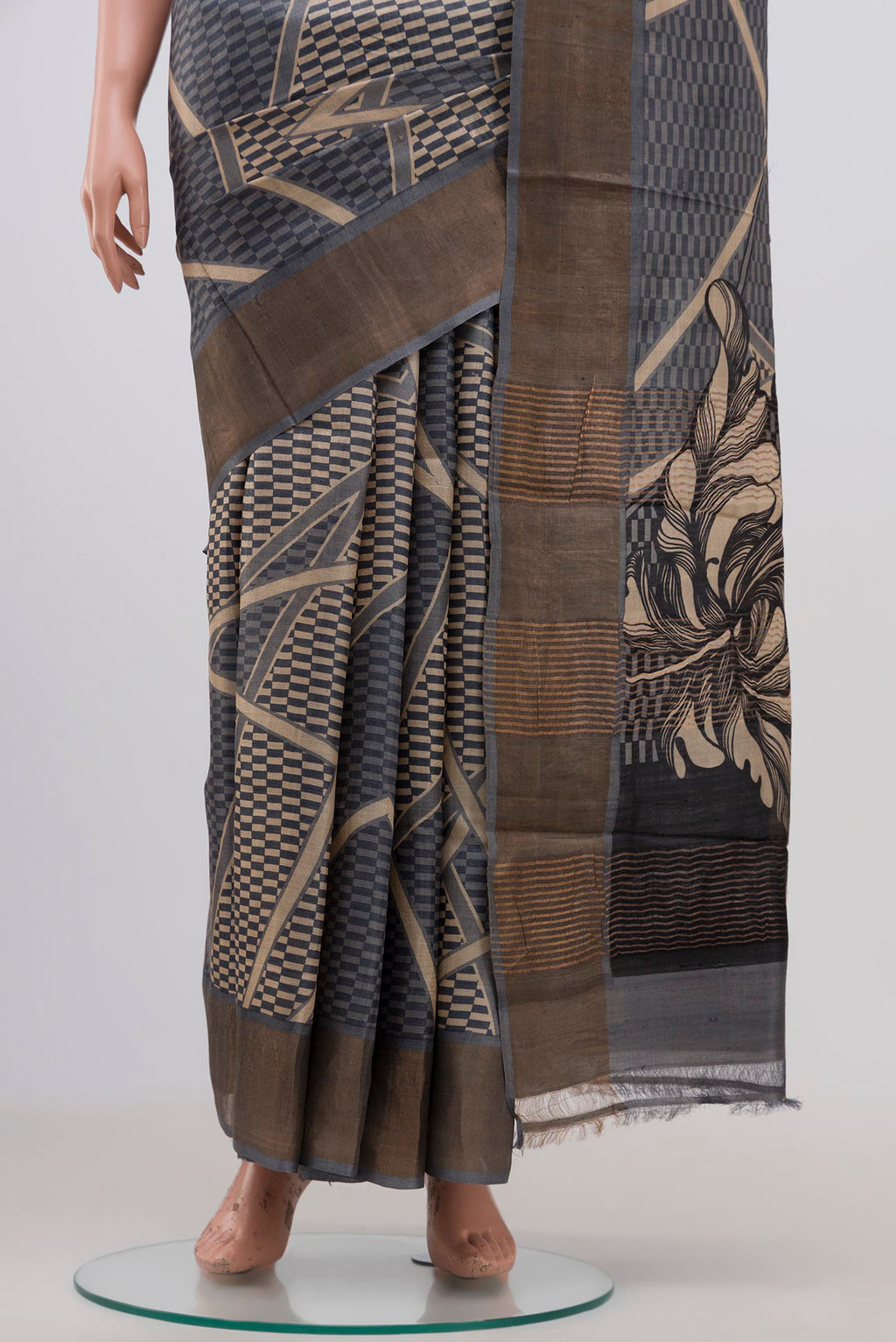 Pleats and pallu of Grey Tussar Silk Saree with Printed design on the body and Zari Border. 