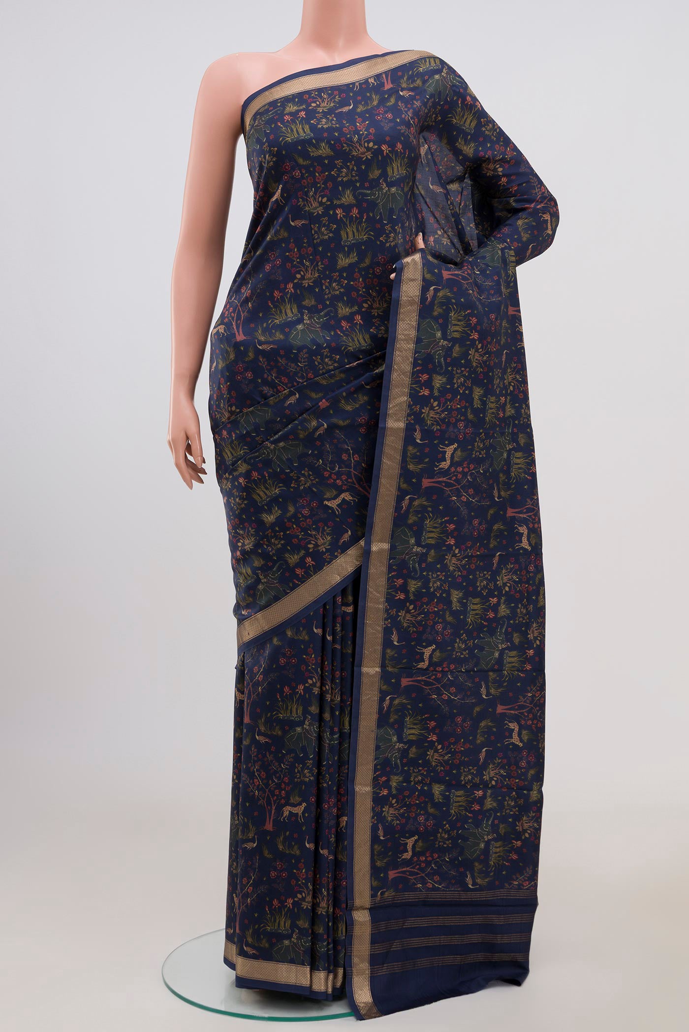 Navy Blue Printed Silk Saree with Printed design on the body and Zari Border.  displayed on a mannequin