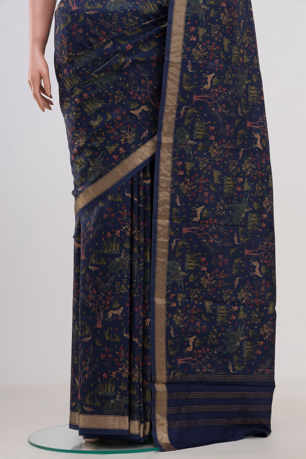 Pleats and pallu of Navy Blue Printed Silk Saree with Printed design on the body and Zari Border. 