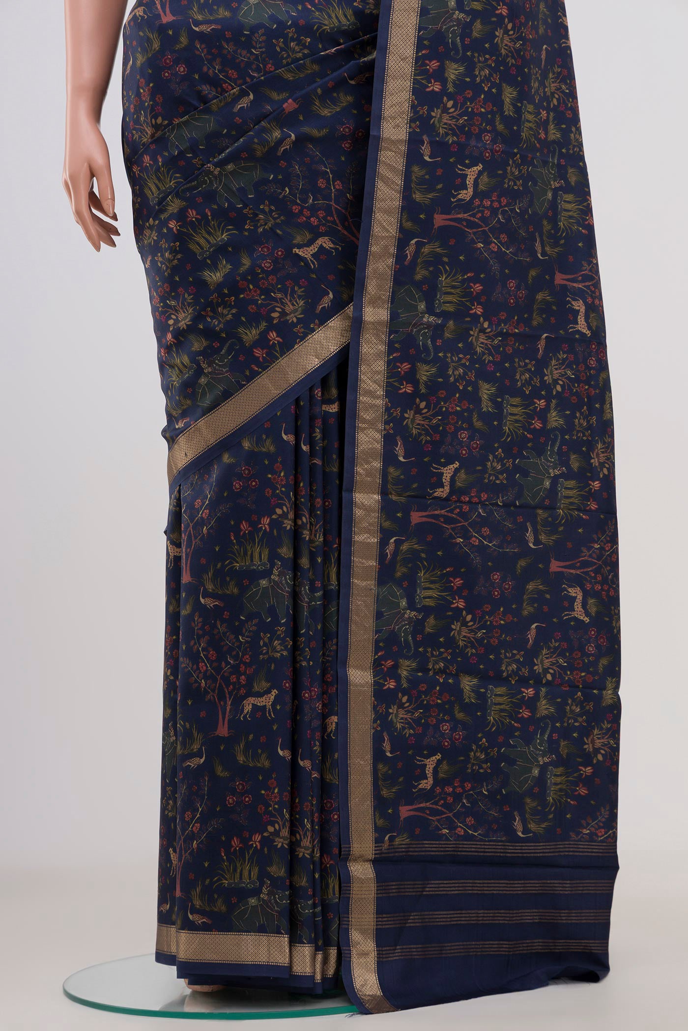 Pleats and pallu of Navy Blue Printed Silk Saree with Printed design on the body and Zari Border. 