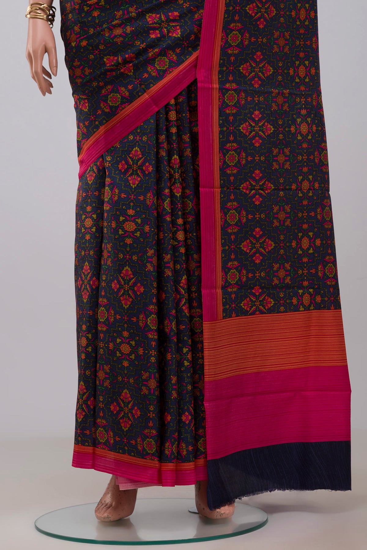 Pleats and pallu of Navy Blue Printed Silk Saree with Printed design on the body and Plain Border. 