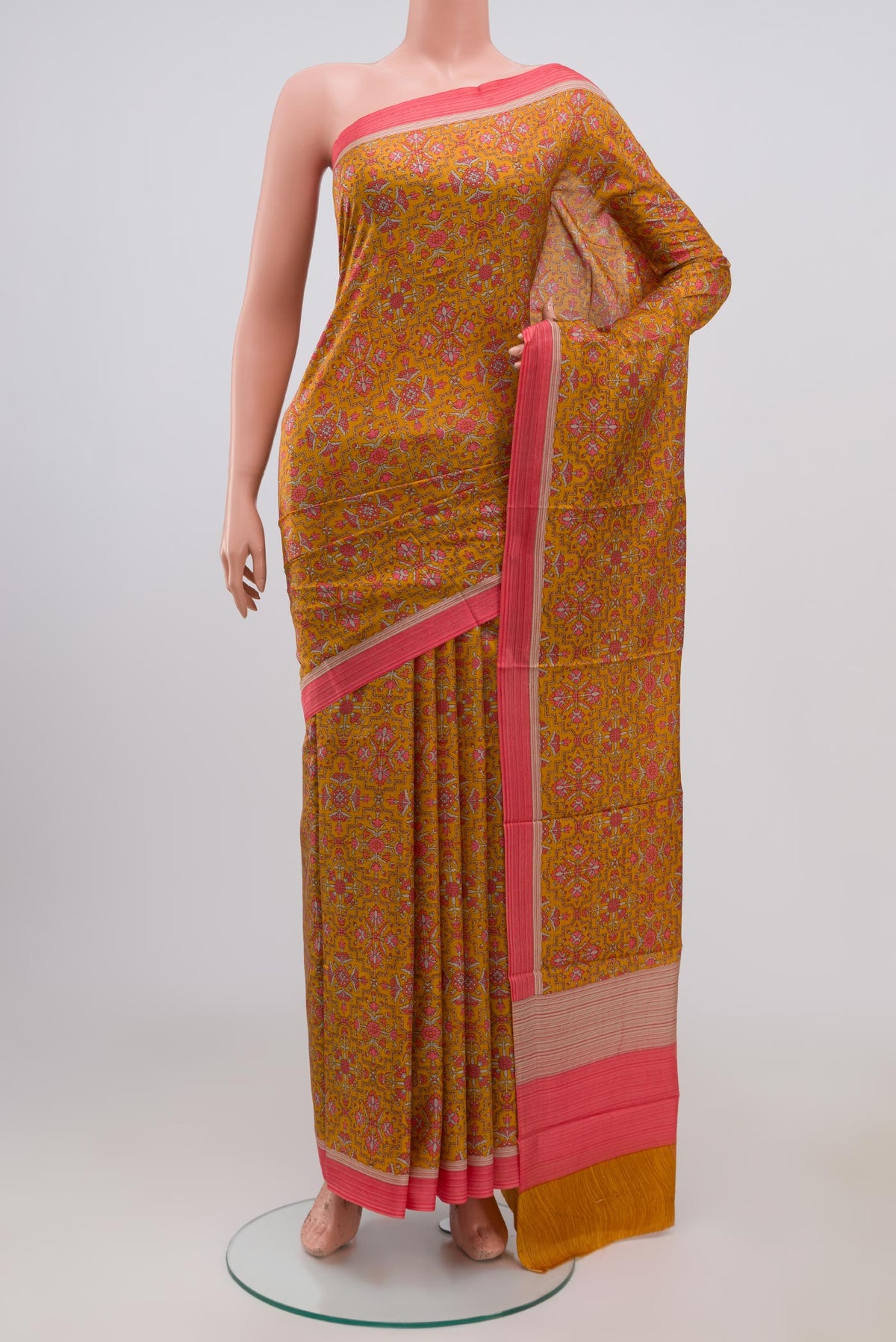 Yellow Printed Silk Saree with Printed design on the body and Plain Border.  displayed on a mannequin
