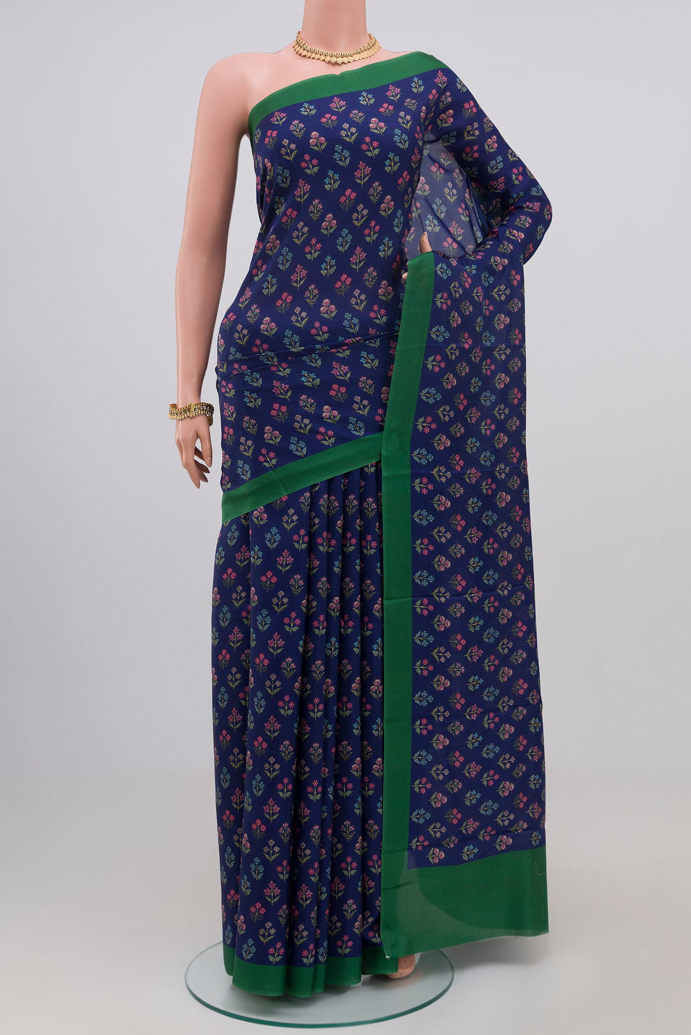 Blue Printed Silk Saree with Printed design on the body and Plain Border.  displayed on a mannequin