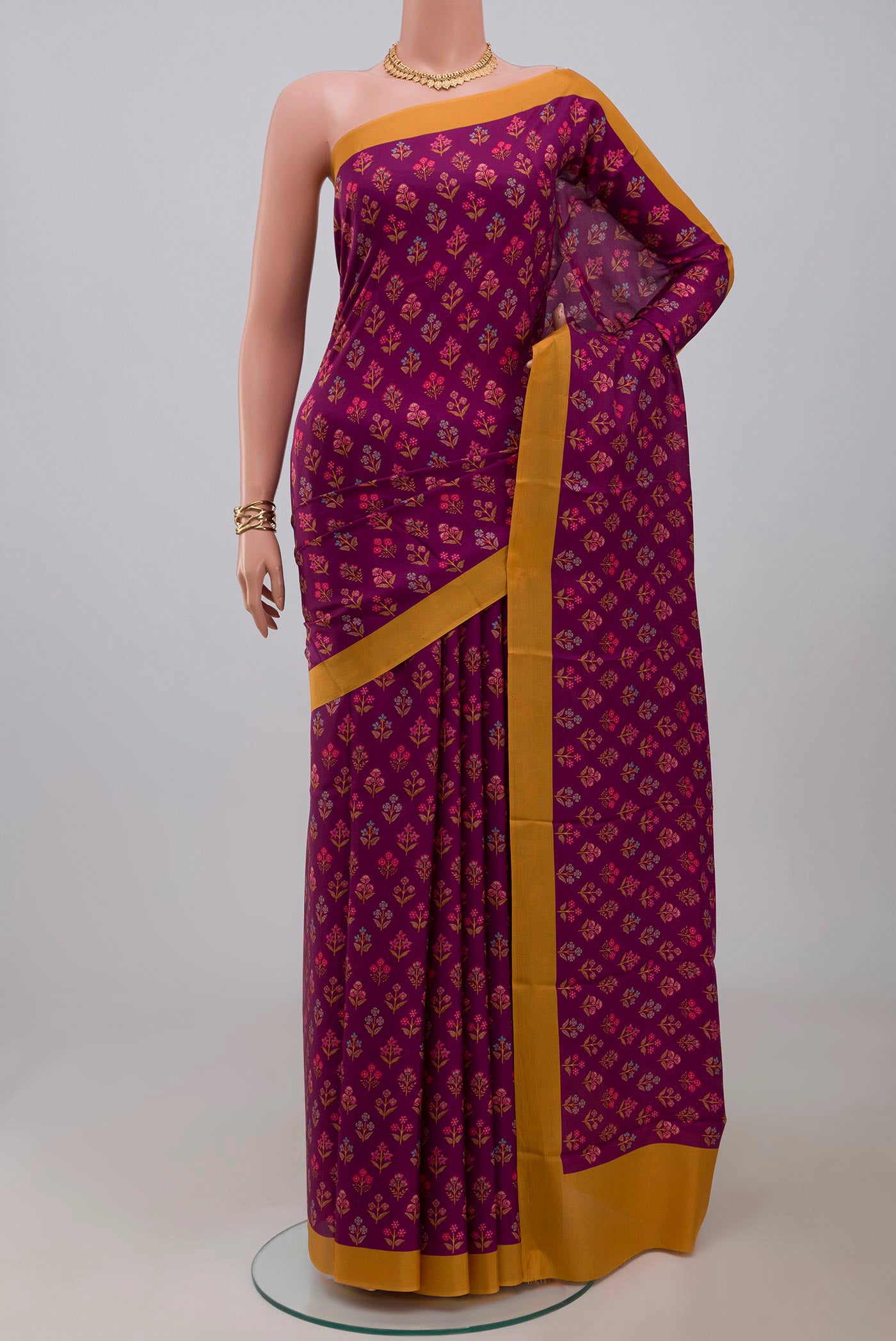 Purple Printed Silk Saree with Printed design on the body and Plain Border.  displayed on a mannequin