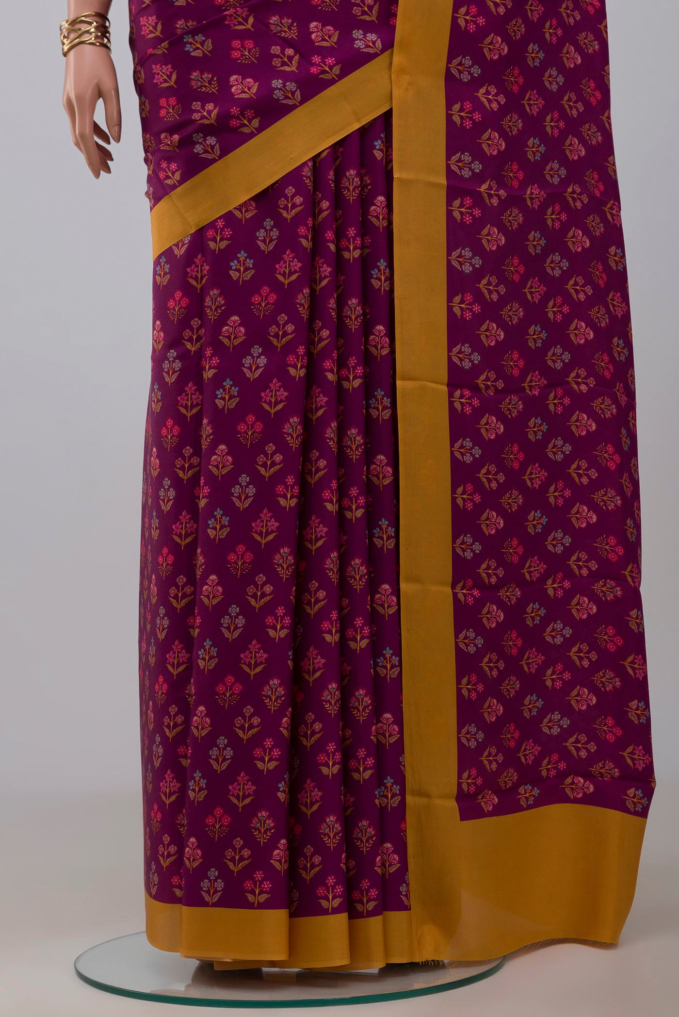 Pleats and pallu of Purple Printed Silk Saree with Printed design on the body and Plain Border. 