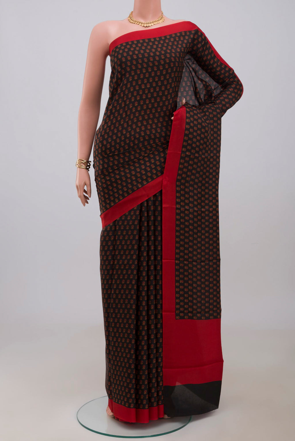 Black Printed Silk Saree with Printed design on the body and Plain Border.  displayed on a mannequin