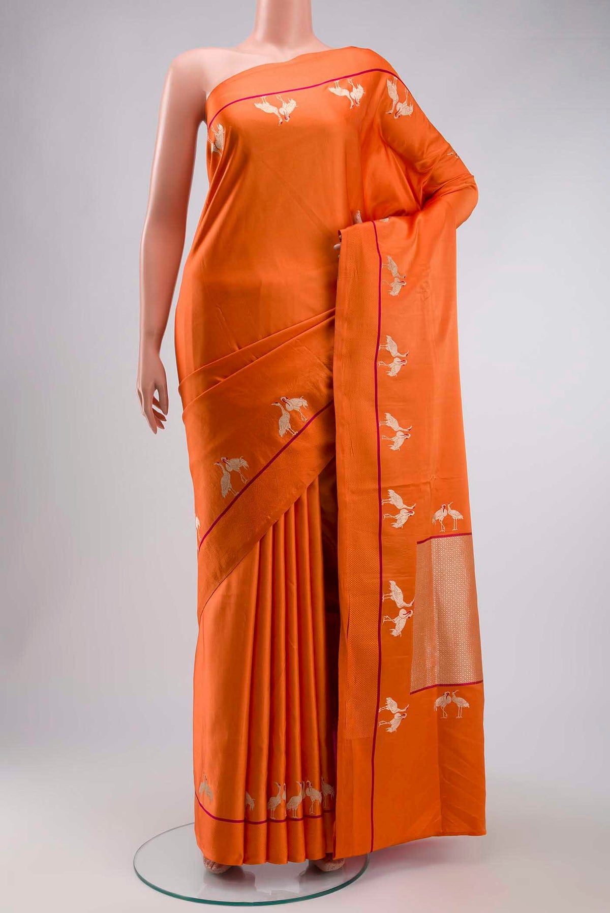 Orange Banarasi Silk Saree with Plain Body and Thread Border displayed on a mannequin
