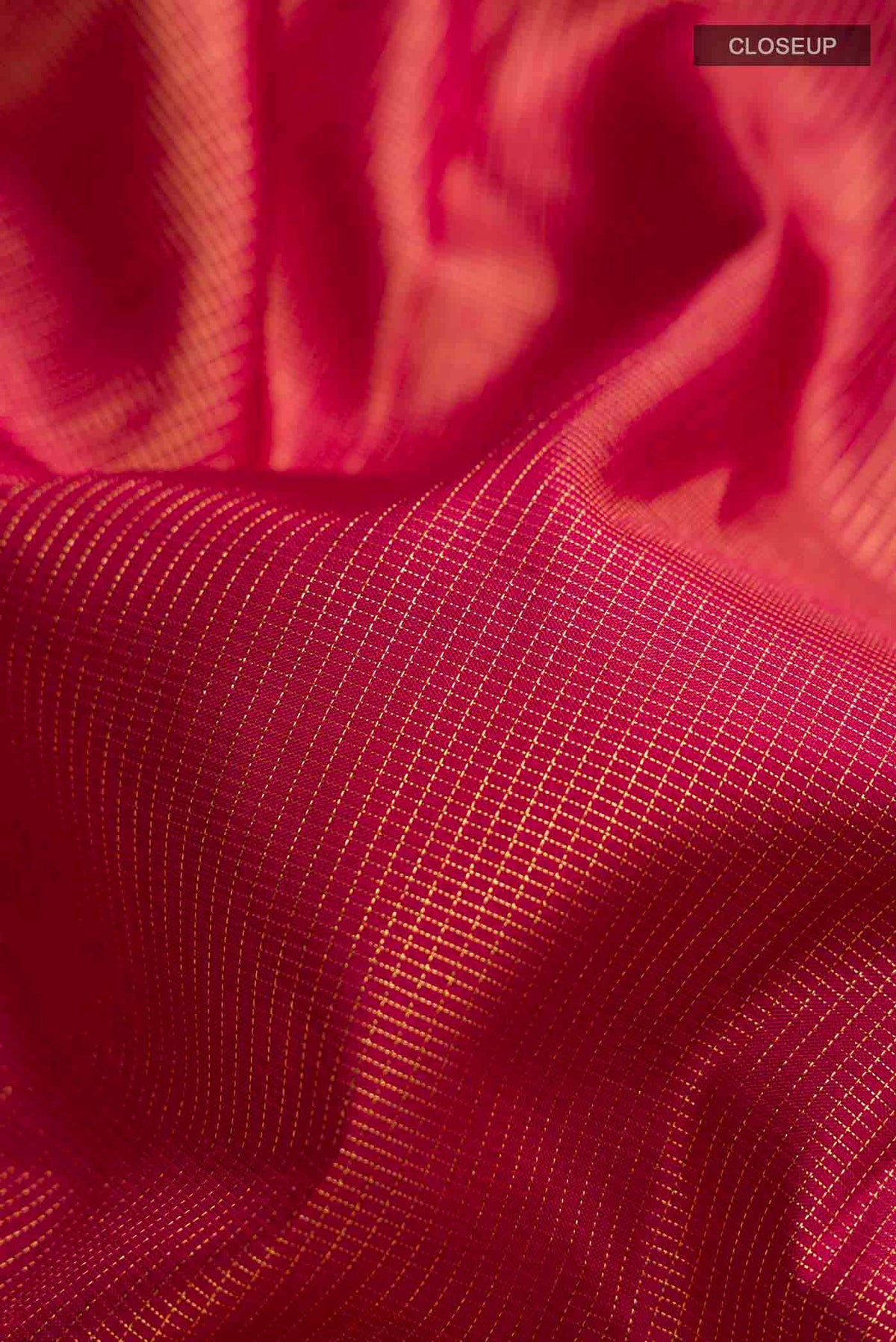 Close up of Maroon Kanchipuram Silk Saree with Checked design on the body and Zari Border displaying folds