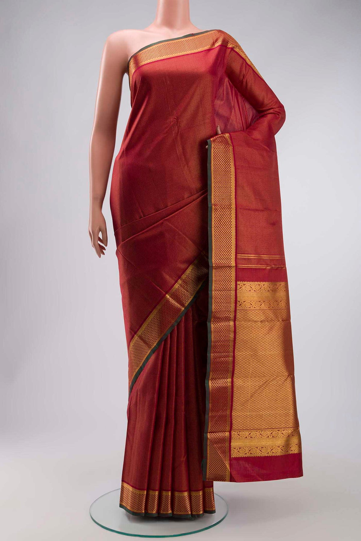 Maroon Kanchipuram Silk Saree with Checked design on the body and Zari Border displayed on a mannequin