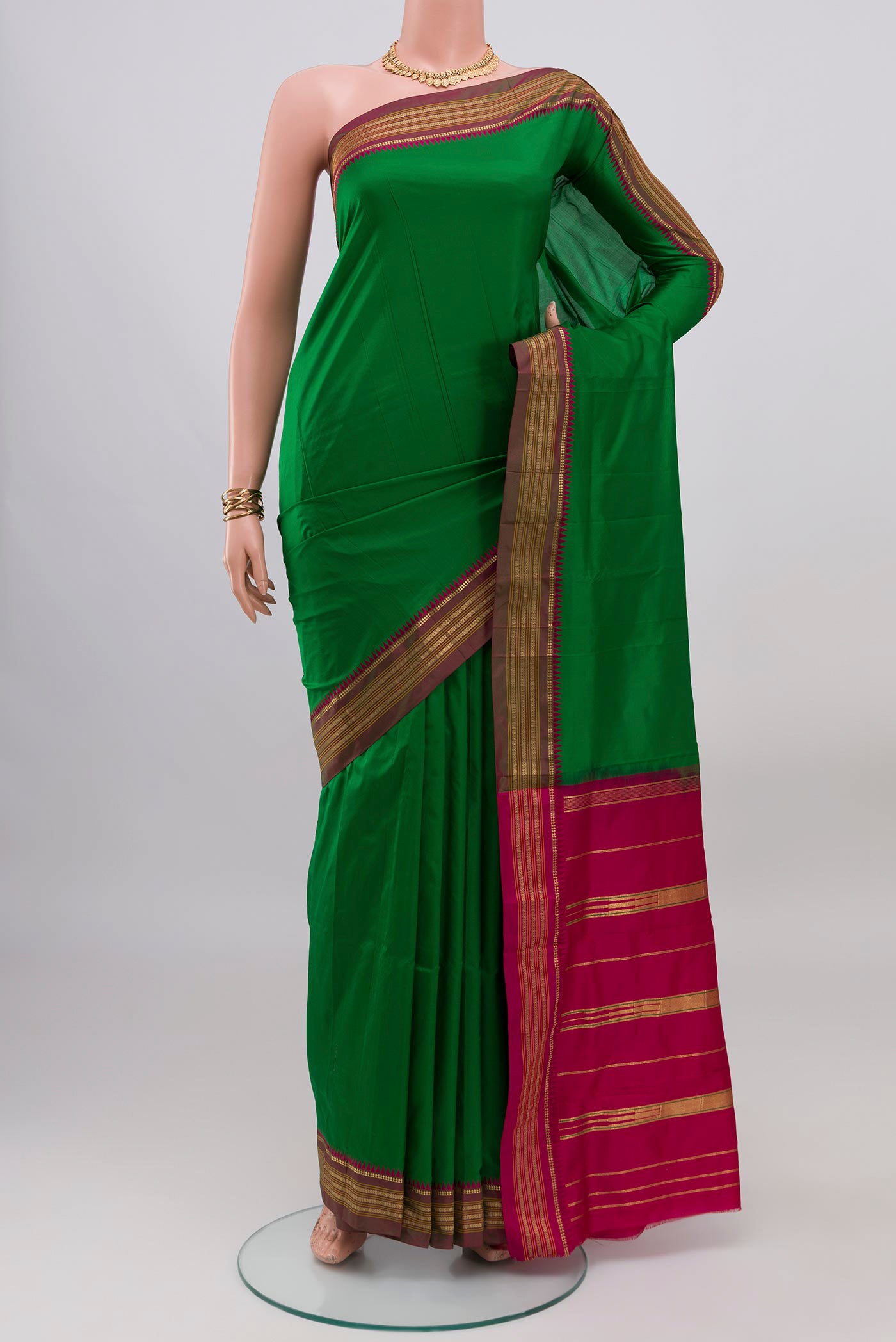 Green Narayanpet Silk Saree with Plain Body and Zari Border.  displayed on a mannequin